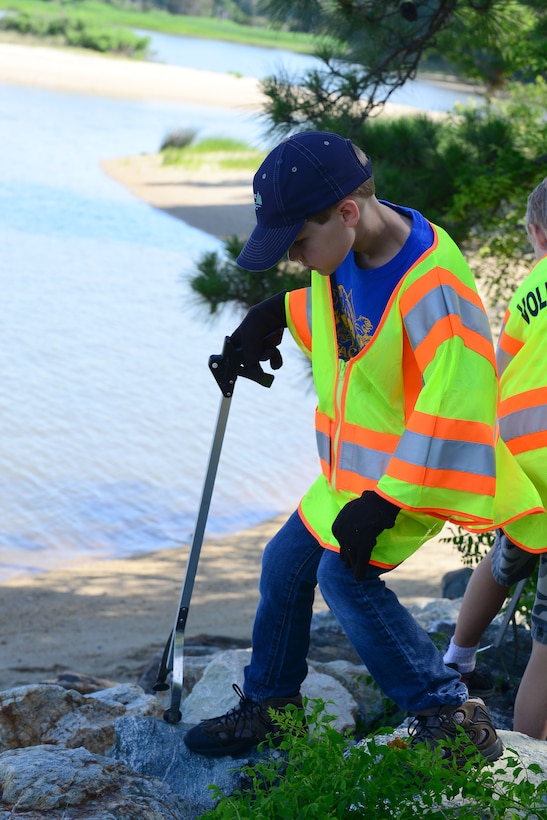 Jared Lawrence, an 8-year-old Cub Scout Pack 143 member, participates in the 26th Annual Clean the Bay Day at Fort Eustis, Va., June 7, 2014. The pack has volunteered with the event annually for more than 20 years. (U.S. Air Force photo by Airman 1st Class Kimberly Nagle/Released)