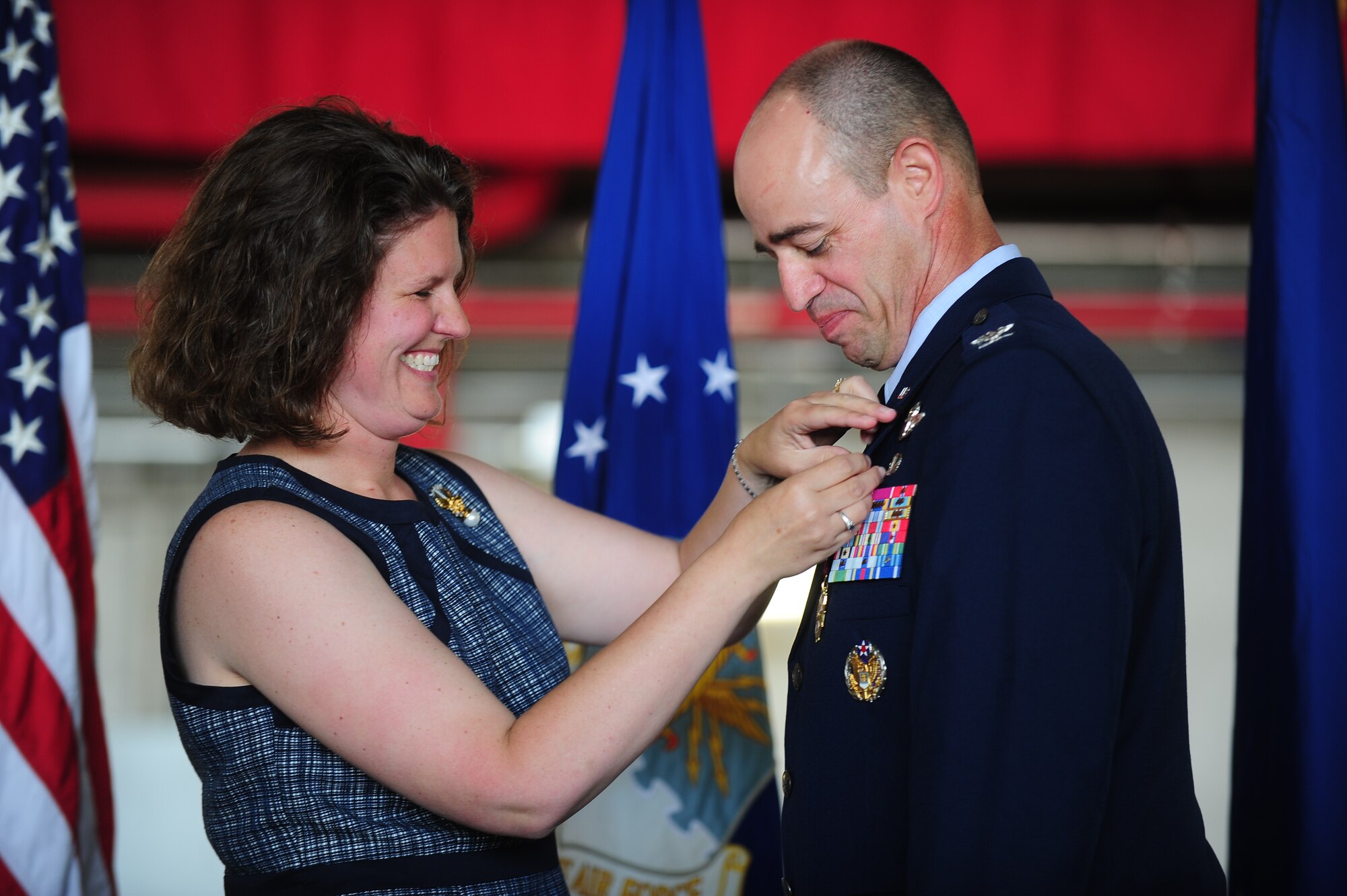 Erica Gantt fastens an Air Force retirement pin onto her husband, Air Force District of Washington Vice Commander Col. Michael E. Gantt, during his retirement ceremony at Joint Base Andrews, Md., June 6.  The Air Force Retired Lapel pin is a pin to commemorate ones retirement from the U.S. Air Force after at least 20 years of service or medical disability. Gantt retired from the U.S. Air Force after serving for more than 26 years. (U.S. Air Force photo/1st Lt. Nathan T. Wallin)