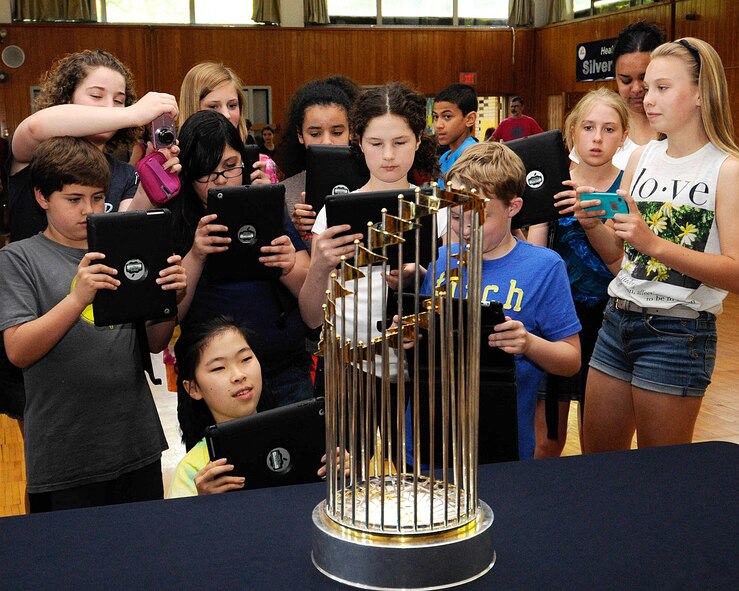 HANSCOM AIR FORCE BASE, Mass. -- Students from the Hanscom Middle School crowd around the Boston Red Sox World Series trophy with cameras, iPads and other portable devices to take photos of the trophy at the school June 3. (U.S. Air Force photo by Linda LaBonte Britt)