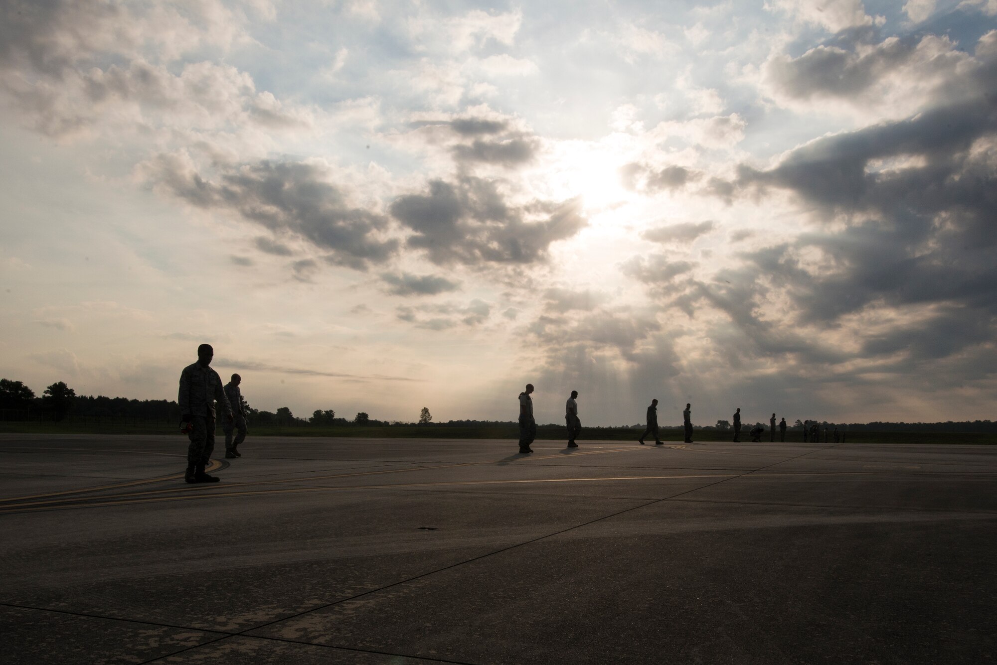 Airmen from the 723d Aircraft Maintenance Squadron perform a foreign-object debris (FOD) walk at Moody Air Force Base, Ga., June 5, 2014. Airmen inspect for FOD, any object laying on the flight line that may damage an aircraft intake, daily. (U.S. Air Force photo by Airman 1st Class Ryan Callaghan/Released)