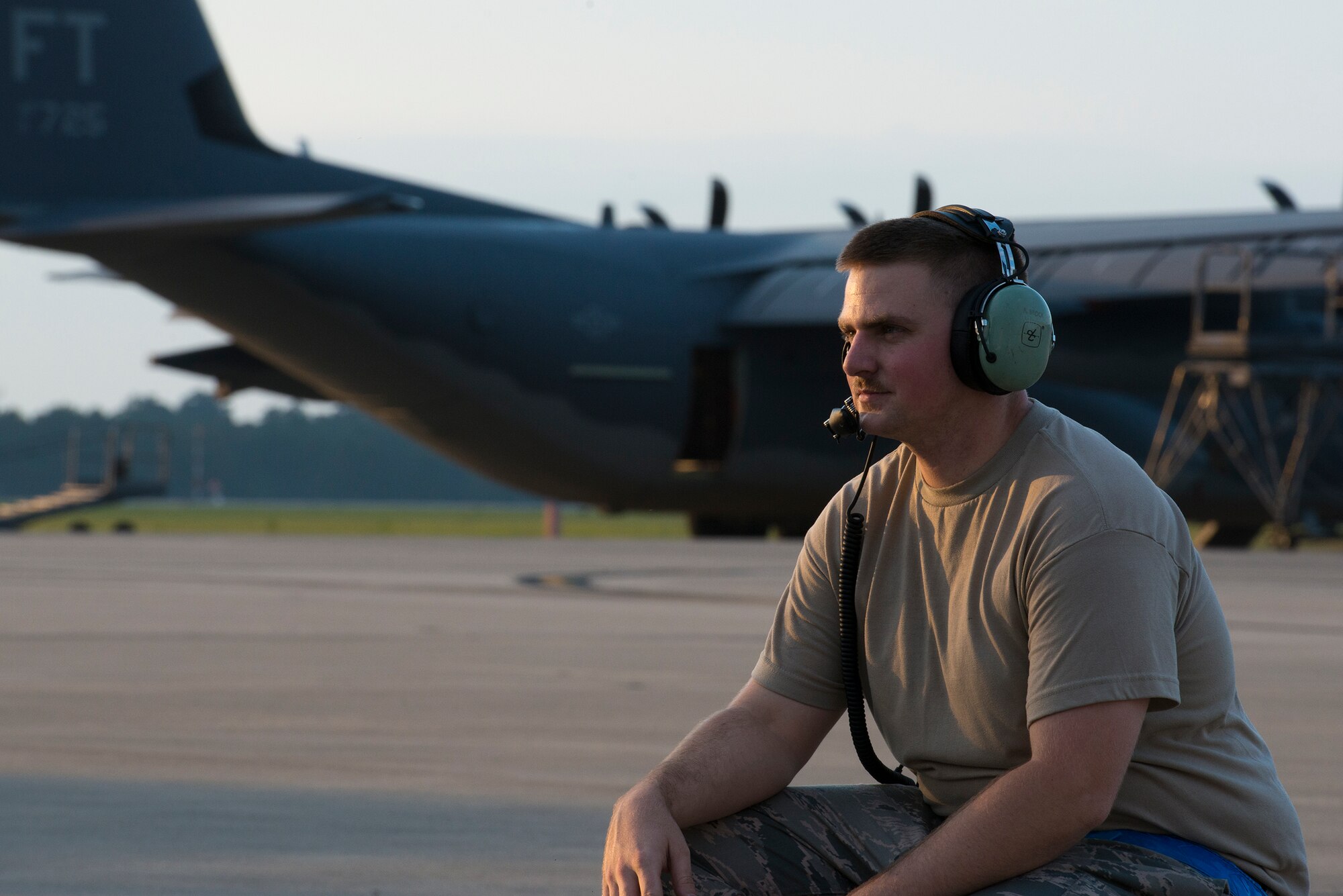 U.S. Air Force Senior Airman Robert Brock, 71st Aircraft Maintenance Unit crew chief, crouches during a pre flight operational check at Moody Air Force Base, Ga., June 5, 2014. Each flight takes approximately eight hours to prepare, including various maintenance, fueling and operations checks. (U.S. Air Force photo by Airman 1st Class Ryan Callaghan/Released)