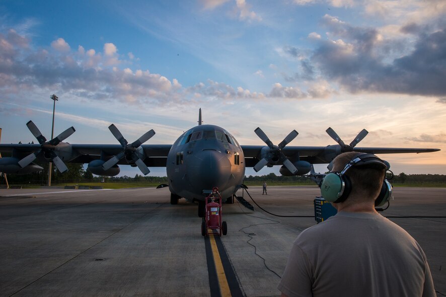 U.S. Air Force Senior Airman Robert Brock, 71st Aircraft Maintenance Unit crew chief, communicates with a 71st Rescue Squadron flight engineer during a pre flight operations check at Moody Air Force Base, Ga., June 5, 2014. Prior to each flight, Airmen test the aircraft’s various systems to ensure they are working properly. (U.S. Air Force photo by Airman 1st Class Ryan Callaghan/Released)