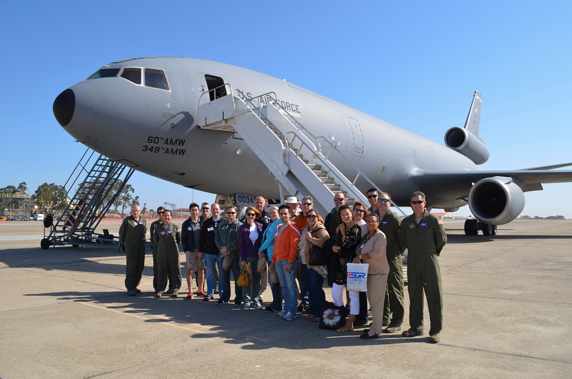 civilian employers and a representative from the California Employer Support of the Guard and Reserve stop for a picture before loading onto am aircraft during the Travis Bosslift held at Travis AFB, Calif. on June 7, 2014. Bosslift allows Air Force Reservists the opportunity to highlight the great work they do during their duty weekend and annual tour to their civilian employers. 