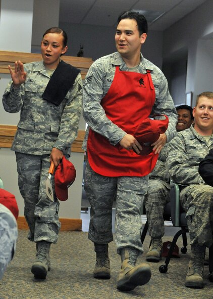 Senior Airman Janae Santos (left) and Staff Sgt. Stephen Marvin, both from the 819th RED HORSE Squadron, are introduced as one of the six teams competing in Warrior Chef June 3. The other five teams were from the 341st Force Support Squadron. The competition was held at Malmstrom’s Dining Facility. (U.S. Air Force photo / John Turner)