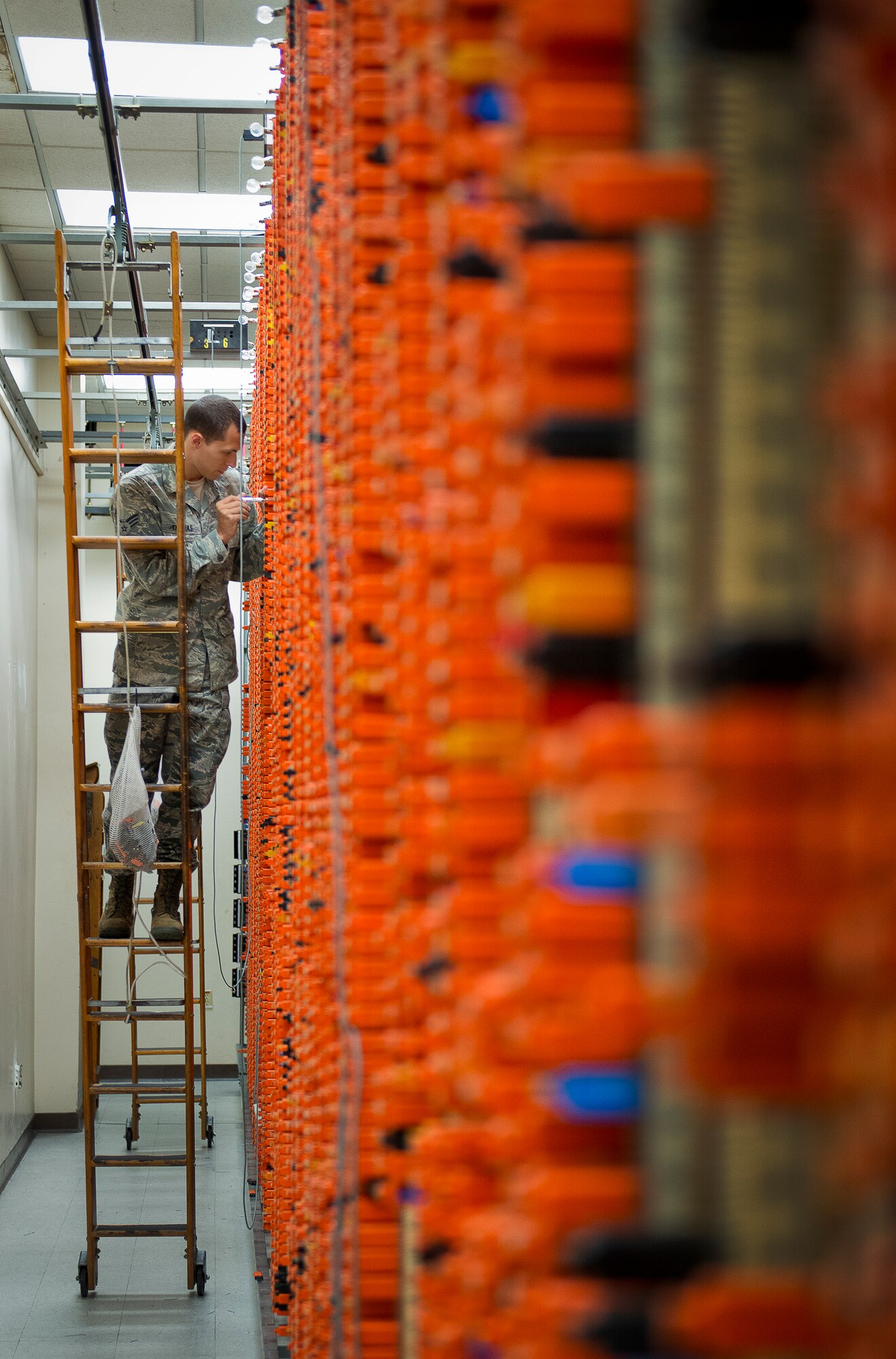 Senior Airman Ryan Thomas, of the 96th Communications Squadron’s voice network systems, completes a wire cross connection of a single phone line located on the main wire distribution frame supporting all copper wire connections on base June 6 at Eglin Air Force Base, Fla.  The 22 Airmen and civilians within voice network systems branch are responsible for the maintenance and preservation of more than 18,000 bases phone lines.  Their contributions combined with the other branches and flights led to the 96th CS earning the 2013 Maj. Gen. Harold McClelland best large communications work center award for Air Force Materiel Command. (U.S. Air Force photo/Samuel King Jr.)