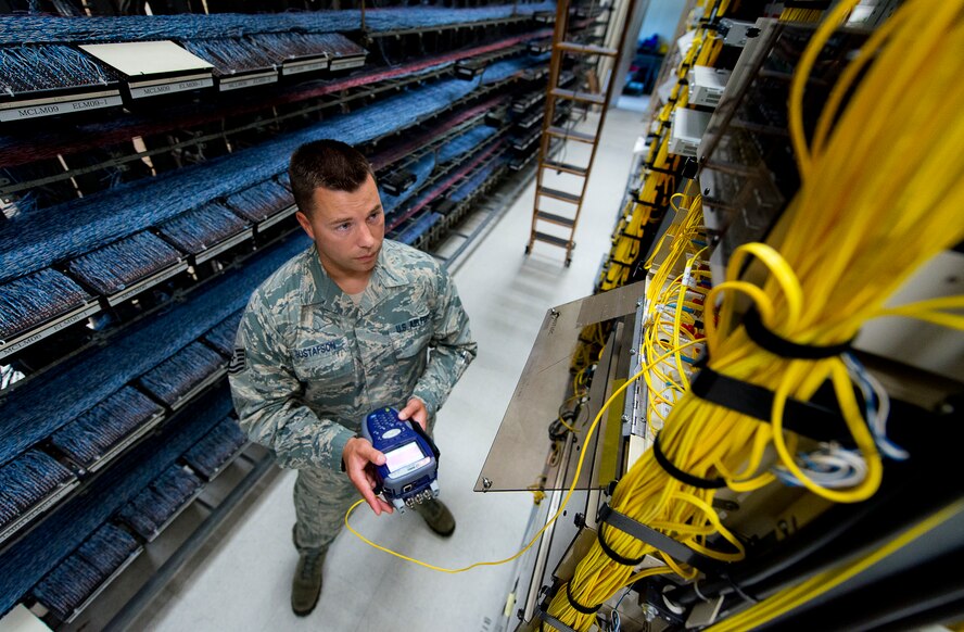 Tech. Sgt. Greg Gustafson, of the 96th Communications Squadron’s voice network systems, tests for telephone signal loss with a fiber tester June 6 at Eglin Air Force Base, Fla.  The 22 Airmen and civilians within voice network systems branch are responsible for the maintenance and preservation of more than 18,000 bases phone lines.  Their contributions combined with the other branches and flights led to the 96th CS earning the 2013 Maj. Gen. Harold McClelland best large communications work center award for Air Force Materiel Command. (U.S. Air Force photo/Samuel King Jr.)