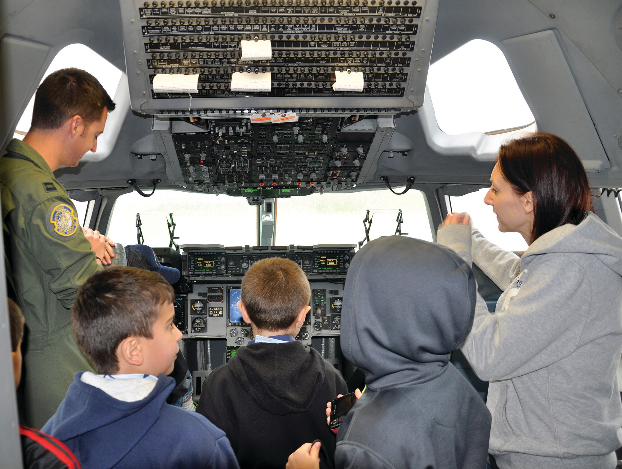 WRIGHT-PATTERSON AIR FORCE BASE, Ohio - Capt. Ryan Armstrong, 89th Airlift Squadron C-17 pilot shows a group of Scouts and their parents the flightdeck of a C-17 Globemaster III during the 445th Airlift Wing Scouts Day May 17. The 445th Airlift Wing hosted its annual Scouts Day May 17. More than 50 Boy and Cub Scouts from around the state enjoyed a morning of activities on the 445th flightline, to include a tour of a base fire truck, and demonstrations by both the 445th Security Forces Squadron and the 445th Aeromedical Evacuation Squadron. (U.S. Air Force photo/Lt. Col. Denise Kerr)