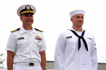 Captain John Fahs, Naval Nuclear Power Training Command commanding officer, stands with Petty Officer 3rd Class Joseph Wagner as he is recognized with the Hard Charger award at during the NNPTC  graduation ceremony of Power School class 1402 June 6, 2014, at Joint Base Charleston – Weapons Station, S.C. (US Navy photo/Petty Officer  2nd Class Jason Pastrick)