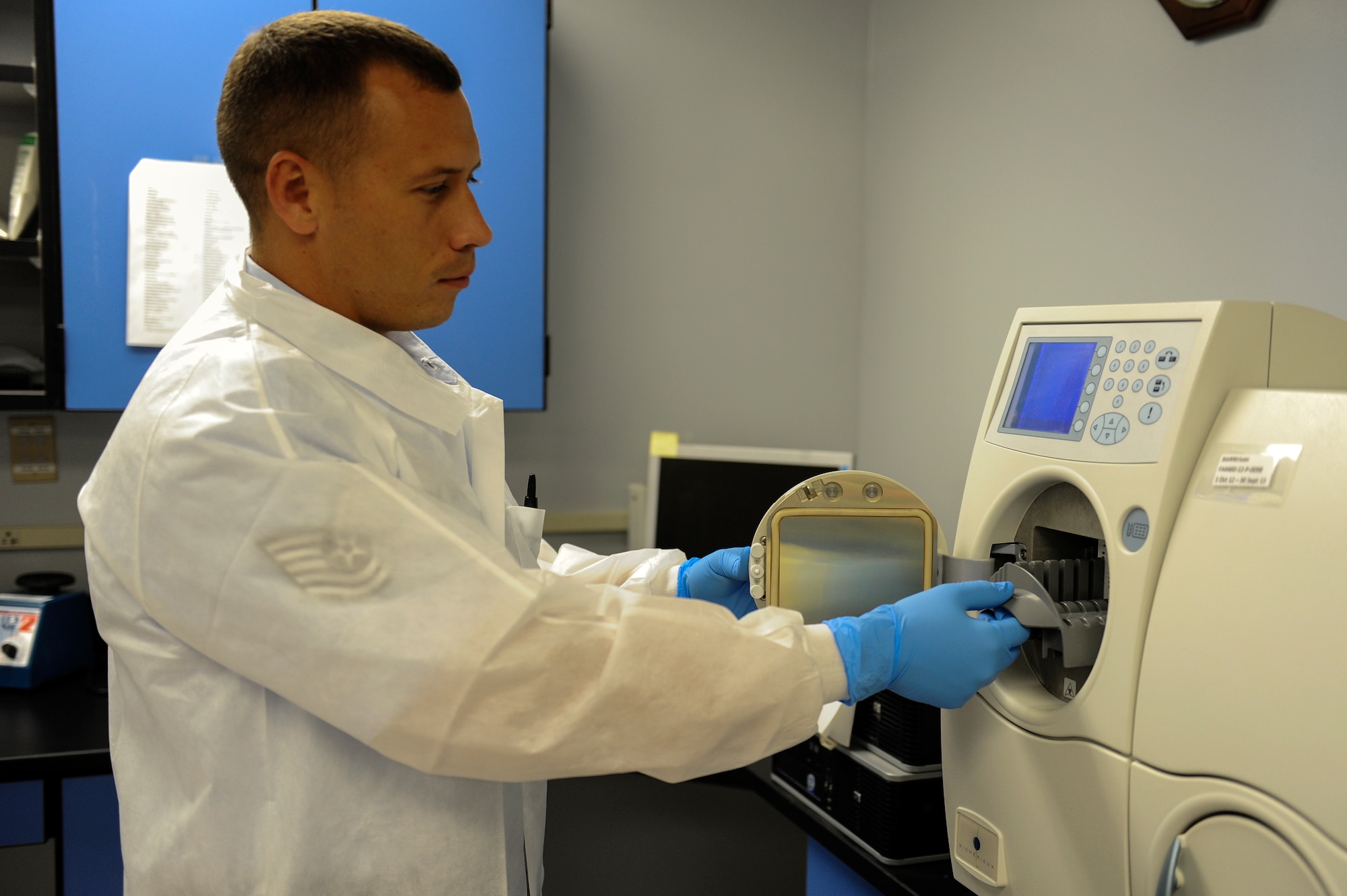 Tech. Sgt. David Bates, the 19th Medical Support Squadron lab noncommissioned officer in charge, performs a quality control check on a VITEK 2 compact incubator June 2, 2014, at Little Rock Air Force Base, Ark. The machine identifies micro-organisms helping doctors determine which antibiotics to use for patient treatment. (U.S. Air Force photo by Staff Sgt. Jessica Condit)