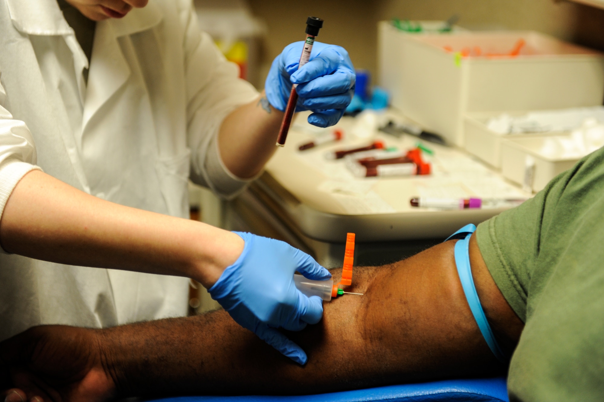 A patient has blood drawn at the base lab May 30, 2014, at Little Rock Air Force Base, Ark. The 19th Medical Support Squadron clinical lab provides support to military active-duty, Guard, retirees, reservists and their family members during normal duty hours. (U.S. Air Force photo by Staff Sgt. Jessica Condit)