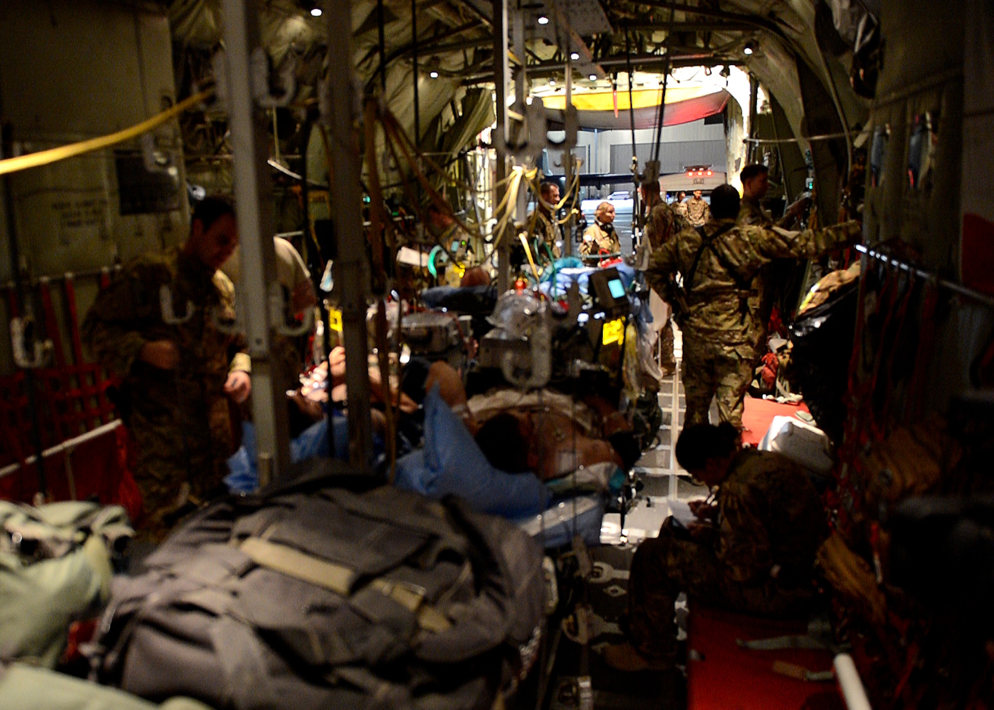 U.S. Air Force Airmen from the 455th Expeditionary Aeromedical Evacuation Squadron prepare to unload patients at Bagram Airfield, Afghanistan May 29, 2014.  The Aeromedical Evacuation squadron transports and treats ill and injured personnel throughout Afghanistan. The unit uses fixed-wing aircraft such as the C-130J Super Hercules, which allows larger patient loads, long-distance transportation and a greater ability to care for injured members. (U.S. Air Force photo by Staff Sgt. Evelyn Chavez/Released)  