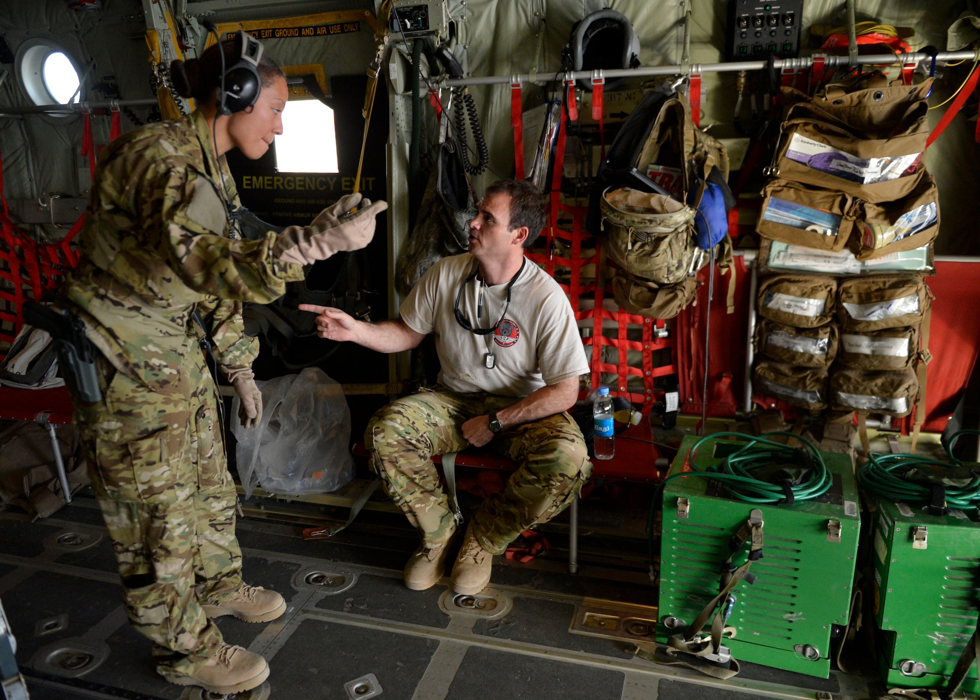 (From left) U.S. Air Force Capts. Cheryl Fowler and Chad Moore, 455th  Expeditionary Aeromedical Evacuation Squadron discuss flight details during a aeromedical evacuation mission at Kandahar Airfield, Afghanistan May 29, 2014.  The Aeromedical Evacuation squadron transports and treats ill and injured personnel throughout Afghanistan. The unit uses fixed-wing aircraft such as the C-130J Super Hercules, which allows larger patient loads, long-distance transportation and a greater ability to care for injured members. Fowler is a flight nurse delpoyed from Peterson Air Force Base, Colo. and a native Watertown S.D.  Moore is a Critical Care Air Transport Team nurse deployed from Wright-Patterson Air Force Base, Ohio. and a native of New Brockton, Ala. (U.S. Air Force photo by Staff Sgt. Evelyn Chavez/Released)  