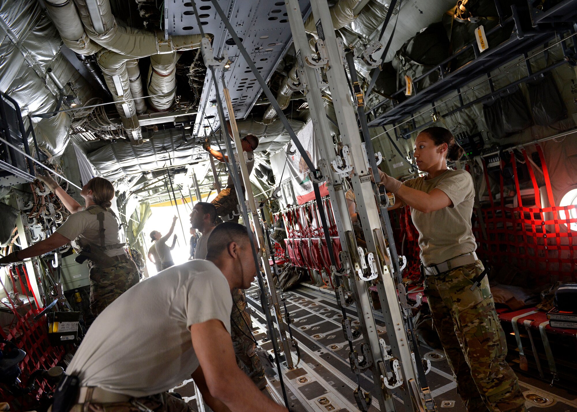 U.S. Air Force Airmen from the 455th Expeditionary Aeromedical Evacuation Squadron prepare a C-130J Super Herucules aircraft for patient transportation at Bagram Airfield, Afghanistan May 29, 2014.  The Aeromedical Evacuation squadron moves injured and sick patients around Afghanistan to a higher level of care. (U.S. Air Force photo by Staff Sgt. Evelyn Chavez/Released)