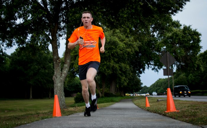 Senior Airman Aaron Bradsher, member of the 560th RED HORSE Squadron, sprints to the finish line during the 5K Fitness Challenge Run June 6, 2014, on Joint Base Charleston, S.C. The Fitness Challenge is held monthly to test Team Charleston’s fitness abilities. Bradsher was the top male runner with a time of 18:34. (U.S. Air Force photo/ Airman 1st Class Clayton Cupit)