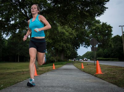 Jessica Ramsey, spouse of 2nd Lt. Philip Ramsey from the 628th Civil Engineer Squadron , pushes to the finish line during the 5K Fitness Challenge Run June 6, 2014, on Joint Base Charleston, S.C. The Fitness Challenge is held monthly to test Team Charleston’s fitness abilities. Ramsey was the top female runner with a time of 19:24. (U.S. Air Force photo/ Airman 1st Class Clayton Cupit)