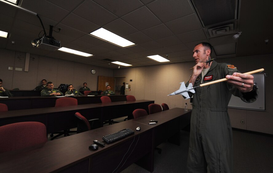 Capt. Brent Ellis, 56th Training Squadron air-to-air subject matter expert, teaches B-Course students air-to-air threat responses May 27 at the 56th TRS building. The course teaches pilots how to maneuver to prevent enemy radar from locking onto aircraft. (U.S. Air Force photo/Staff Sgt. Luther Mitchell Jr.)