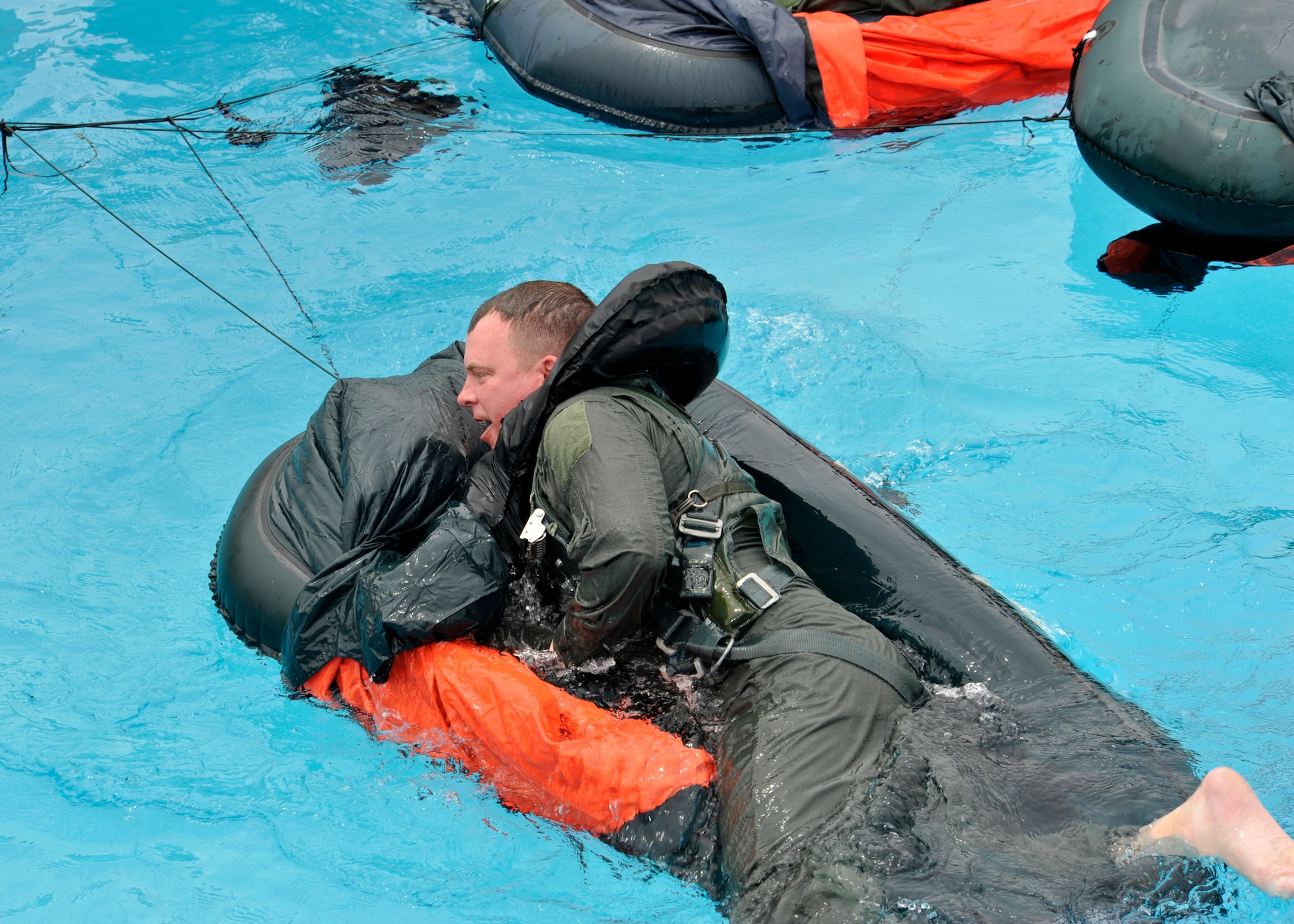 Maj. Brendan Shannon, 309th Fighter Squadron director of operations, climbs into a one-man raft. When a pilot ejects, survival equipment, including a life raft, is ejected with the seat and is inflated by the time the pilot lands in the water. (U.S. Air Force photo/Senior Airman Marcy Copeland)