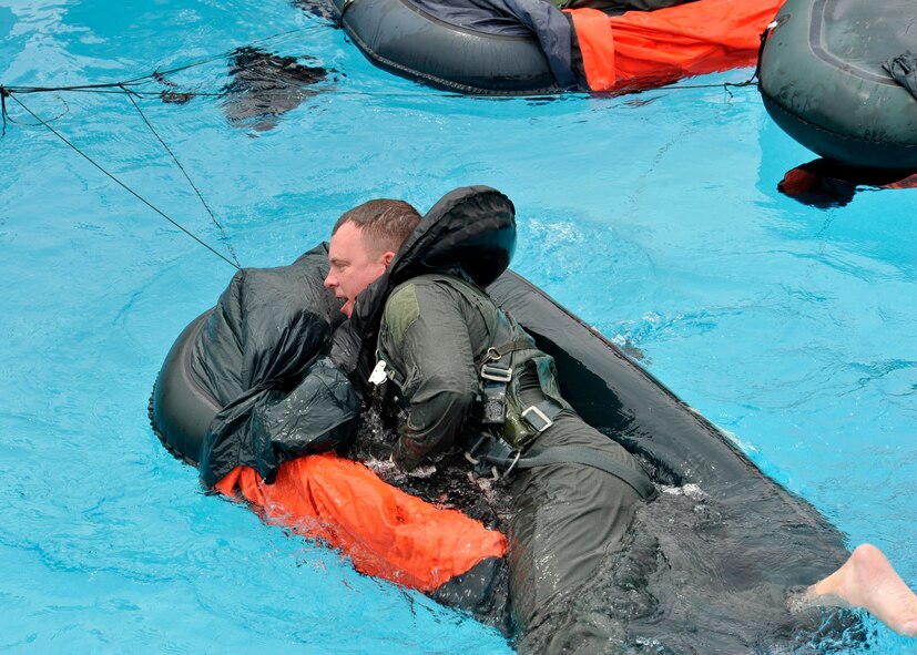 Maj. Brendan Shannon, 309th Fighter Squadron director of operations, climbs into a one-man raft. When a pilot ejects, survival equipment, including a life raft, is ejected with the seat and is inflated by the time the pilot lands in the water. (U.S. Air Force photo/Senior Airman Marcy Copeland)