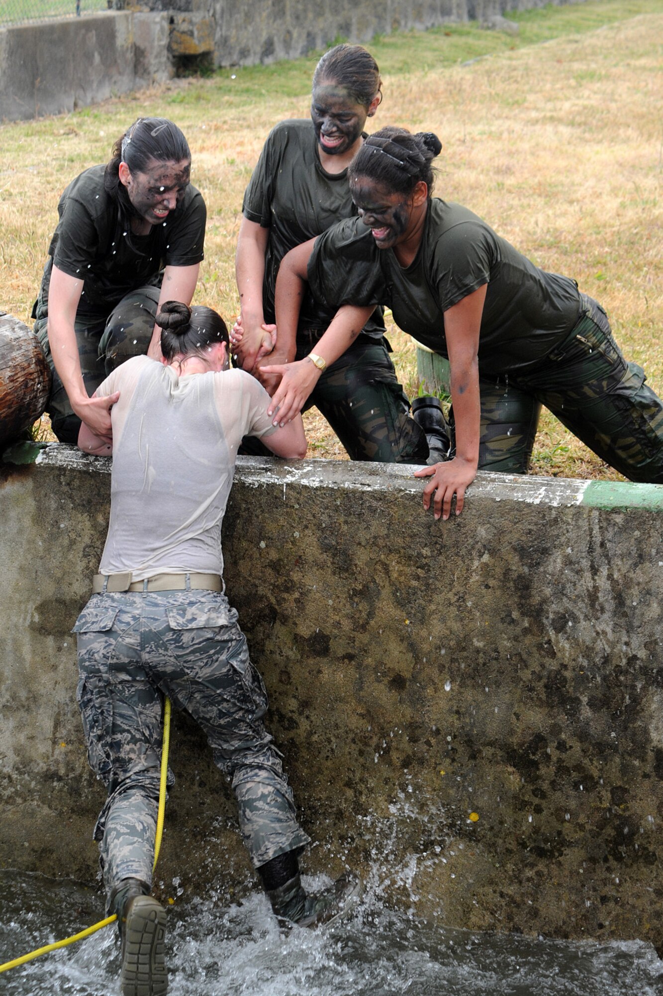 U.S. and Portuguese Air Force Airmen compete in the Defender Challenge May 30, 2014, at Lajes Field, Azores, Portugal.  The PoAF held the Defender Challenge in celebration of the 59th anniversary of the Air Police Squadron. The challenge tested the Airmen’s strength, endurance and ability to work together to accomplish tasks. (U.S. Air Force photo by Guido Melo/Released)
