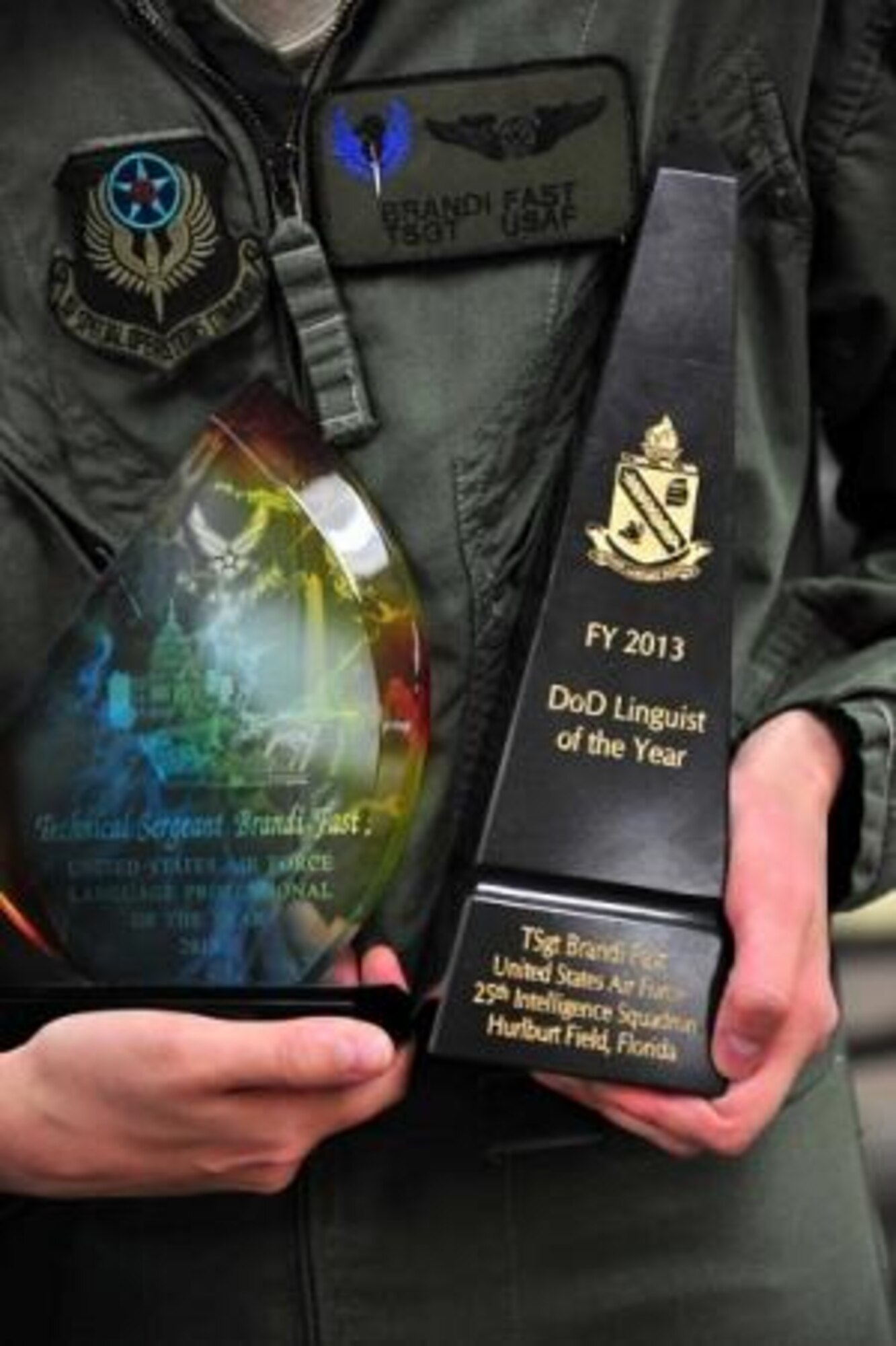 Tech. Sgt. Brandi Fast of the 25th Intelligence Squadron, Hurlburt Field, Fla., holds the hardware presented to her June 3 as the 2013 Defense Department's Language Professional of the Year. The award period spanned Oct. 1, 2012 to Sept. 30, 2013. (Defense Language Institute Foreign Language Center photo by Natela Cutter)  