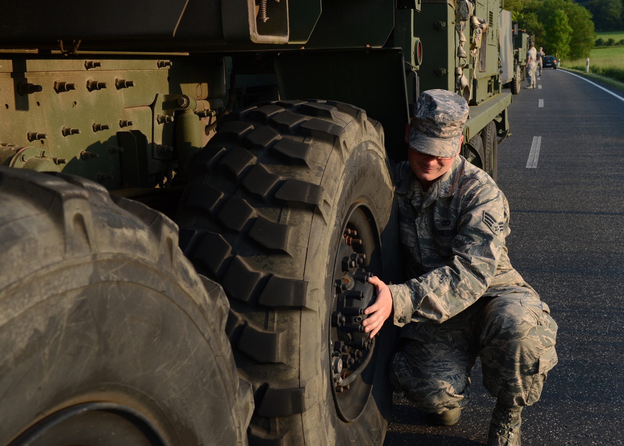 U.S. Air Force Senior Airman Robert Gordon, 606th Air Control Squadron power production apprentice, conducts a hot brake check on route to Powidz Air Base, Poland, June 3, 2014. There were three groups of vehicles that left Spangdahlem Air Base, Germany, convoying nearly 90 U.S. Airmen to Poland. The vehicles transported equipment to set up air-to-ground communication in support of Exercise EAGLE TALON and U.S. Aviation Detachment Rotation 14-3, both exercises that increase NATO interoperability. (U.S. Air Force photo by Airman 1st Class Kyle Gese/Released)