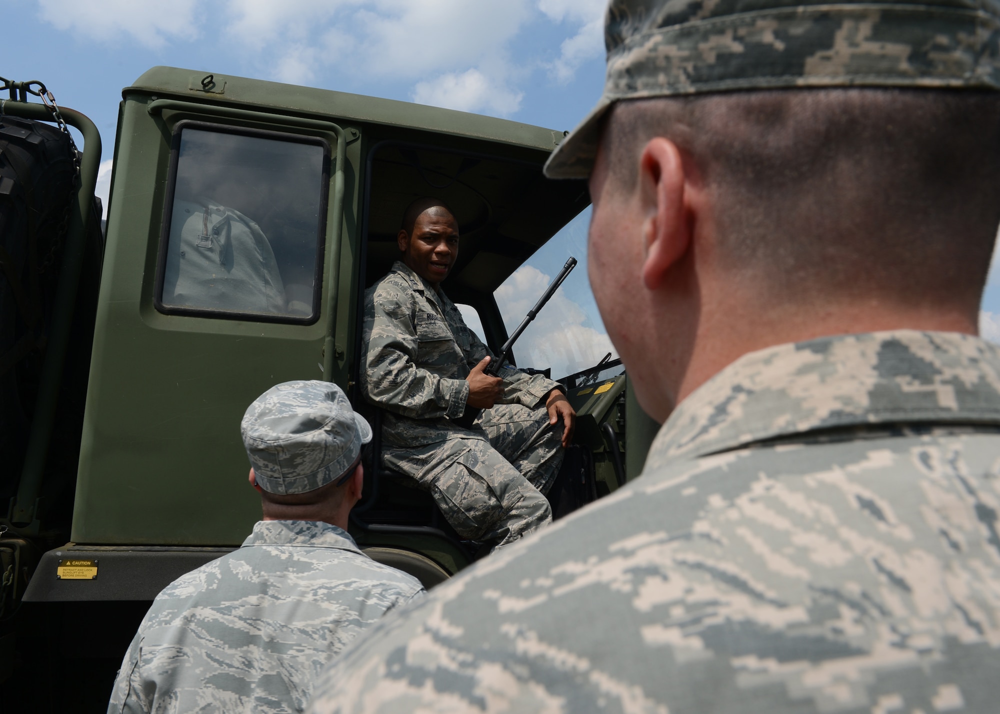 U.S. Air Force Senior Airman Bobby Gordon, 606th Air Control Squadron power production apprentice and U.S. Air Force Capt. Romaine Russell, 606th Air Control Squadron bravo convoy commander, gives instructions to U.S. Airmen during a stop in the second longest convoy in the history of the 606th ACS, June 2, 2014. Each vehicle in the convoy had at least two people, a driver and passenger, to safely drive long distances from Spangdahlem Air Base, Germany, to Powidz Air Base, Poland to provide air control support to NATO assets participating in Polish-led Exercise EAGLE TALON and U.S. Aviation Detachment Rotation 14-3. These training exercises aim to increase NATO partnership capacity for future real-world scenarios. (U.S. Air Force photo by Airman 1st Class Kyle Gese/Released)