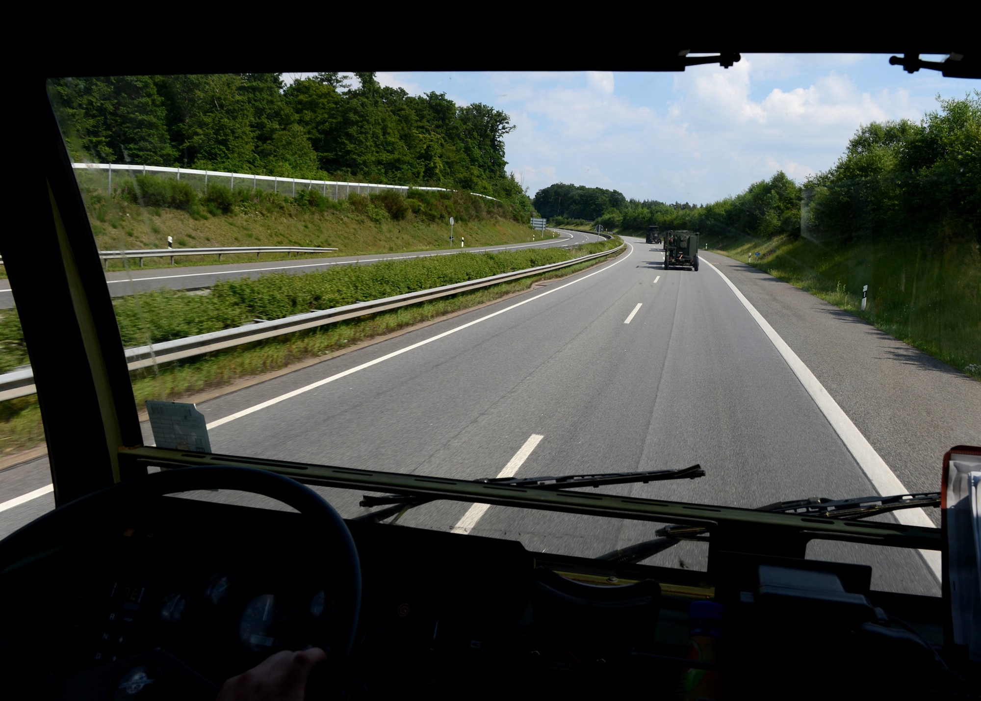 A U.S. Air Force convoy drives on the autobahn in Germany toward Poland to provide air control for NATO air assets participating in various military training events, June 2, 2014. The 606th Air Control Squadron, Spangdahlem Air Base, Germany, is supporting the Polish-led Exercise EAGLE TALON and U.S. Aviation Detachment Rotation 14-3. Poland and U.S. share a strong military partnership and train together to increase readiness in support for NATO operations. (U.S. Air Force photo by Airman 1st Class Kyle Gese/Released)