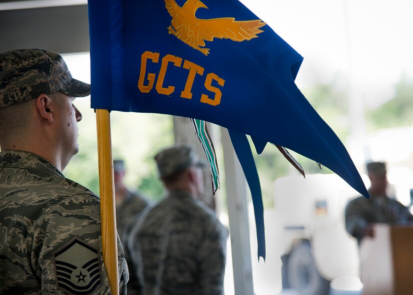 Master Sgt. Tim Greene holds the 96th Ground Combat Training Squadron guidon as its commander, Maj. James Habeck speaks during the squadron’s inactivation ceremony June 6 at Eglin Air Force Base, Fla.  The squadron will be fully deactivated by Oct. 1 and its mission of training deploying security forces Airmen will move to Fort Bliss, Texas.  (U.S. Air Force photo/Samuel King Jr.)