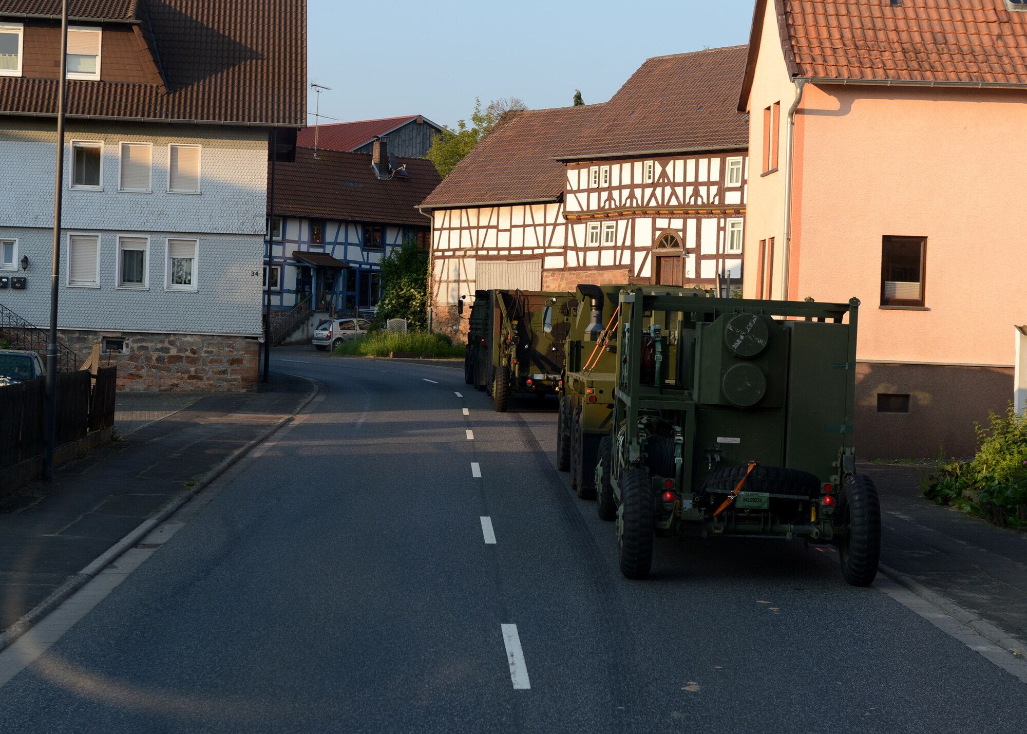 A U.S. Air Force convoy drives through a village on the route to Powidz Air Base, Poland, June 2, 2014. The 45 vehicles from the 606th Air Control Squadron of Spangdahlem Air Base, Germany, carried nearly 90 U.S. Airmen to provide ground-to-air communication to NATO air assets training during Poland’s Exercise EAGLE TALON and U.S. Aviation Detachment Rotation 14-3. This was the second longest convoy in the history of 606th ACS. (U.S. Air Force photo by Airman 1st Class Kyle Gese/Released)