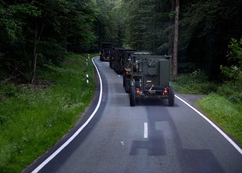 A U.S. Air Force convoy drives through heavily wooded areas on route to Powidz Air Base, Poland, June 2, 2014. The 606th Air Control Squadron is supporting the Polish national Exercise EAGLE TALON for the first time by providing ground-to-air communications for NATO air assets. Close to 90 U.S. Airmen run the twenty-four hour operations to support NATO training in Poland. (U.S. Air Force photo by Airman 1st Class Kyle Gese/Released)