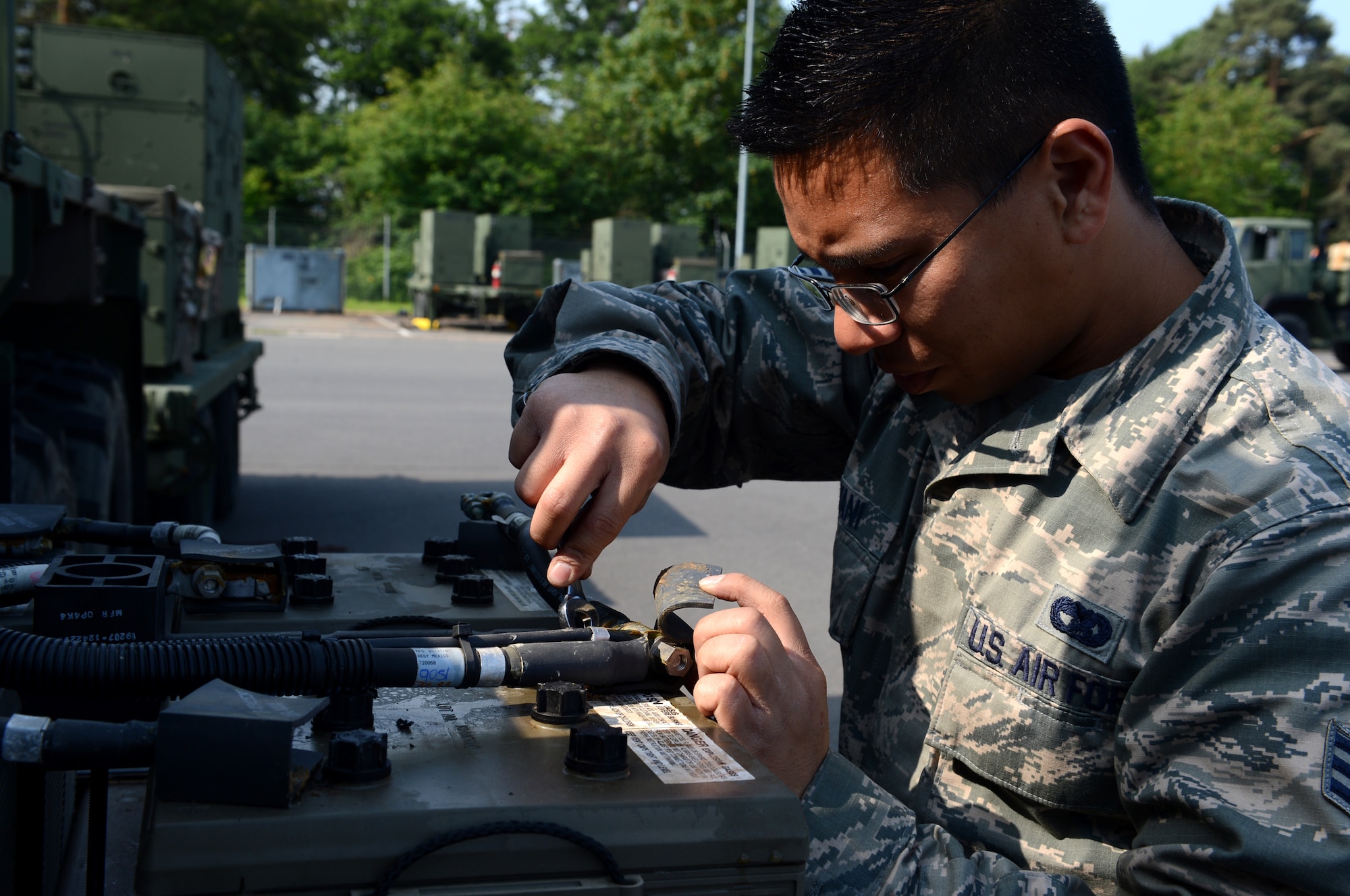 U.S. Air Force Senior Airman Andrew Bayani, 606th Air Control Squadron vehicle maintenance technician, disconnects a battery from a truck at Spangdahlem Air Base, Germany, June 2, 2014. Bayani performed maintenance on the trucks in preparation for a convoy to Powidz Air Base, Poland. The 606th ACS is providing valuable air control during Poland’s Exercise EAGLE TALON and the U.S. Aviation Detachment Rotation 14-3, both routine exercises that increase interoperability through training with NATO partners.  (U.S. Air Force photo by Airman 1st Class Kyle Gese/Released)