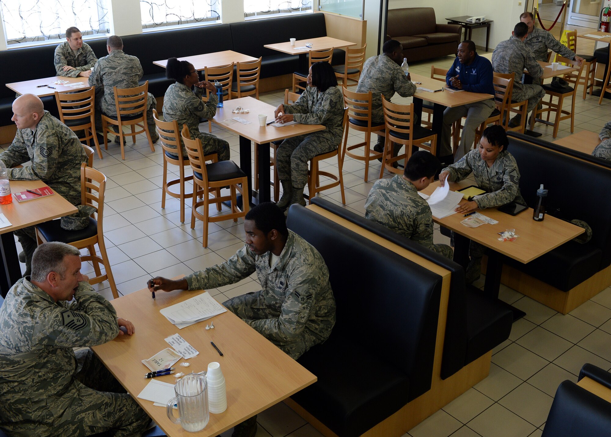 U.S. Air Force Airmen participate in the first 52nd Force Support Squadron speed-mentoring event in the Mosel Dining Hall at Spangdahlem Air Base, Germany, June 6, 2014. Thirteen senior enlisted volunteered to become mentors to the 12 participating Airmen. The event coordinators gave the participating Airmen three minutes to talk with the potential mentors, a time which did not allow for deep discussion but rather offered a chance to gauge compatibility. (U.S. Air Force photo by Staff Sgt. Daryl Knee/Released)