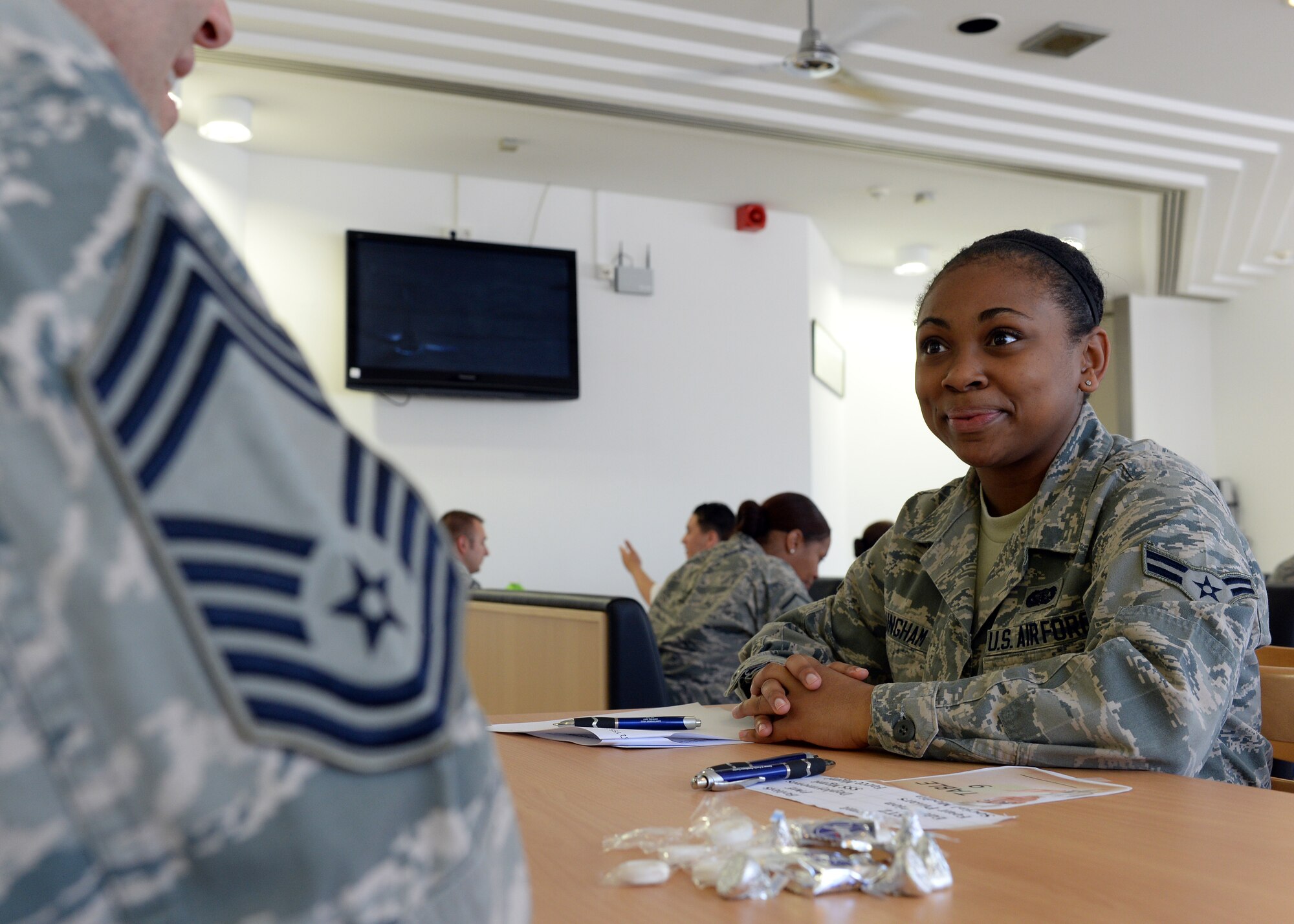 U.S. Air Force Airman 1st Class Jessica Cunningham, 52nd Force Support Squadron Mosel Dining Hall staff member from San Antonio, speaks with U.S. Air Force Chief Master Sgt. Art Roy, 52nd Civil Engineer Squadron Operations Flight superintendent from Gorham, N.H., during the inaugural FSS speed-mentoring event June 6, 2014, in the dining facility at Spangdahlem Air Base, Germany. Roy has earned the highest enlisted rank for the U.S. Air Force and volunteered his time to mentor junior Airmen on how to be successful as a service member. (U.S. Air Force photo by Staff Sgt. Daryl Knee/Released)