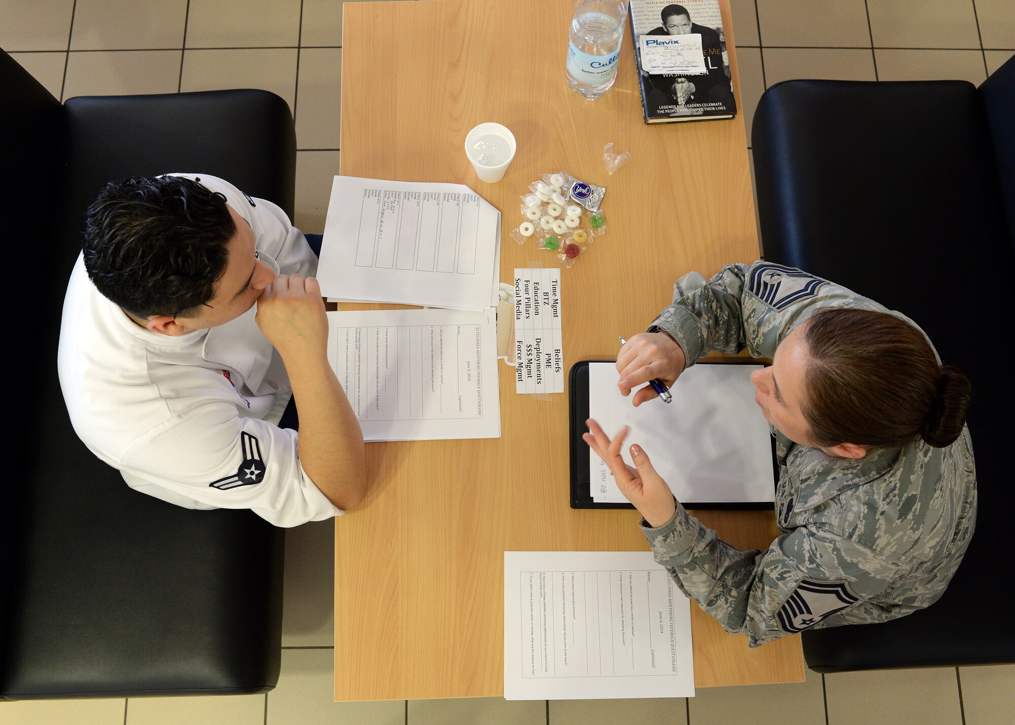 U.S. Air Force Senior Airman Henry Hernandez, left, 52nd Force Support Squadron Mosel Dining Hall staff member from Pembroke Pines, Fla., interviews U.S. Air Force Senior Master Sgt. Jennifer Brembah, 52nd FSS superintendant from Bremerton, Wash., during the first speed-mentoring event in the dining facility at Spangdahlem Air Base, Germany, June 6, 2014. Airmen interviewed senior Air Force members to judge compatibility for a possible mentor-mentoree role. Each table had topics available for the interviewer to ask the senior member, such as their beliefs on time management, deployments and social media. (U.S. Air Force photo by Staff Sgt. Daryl Knee/Released)