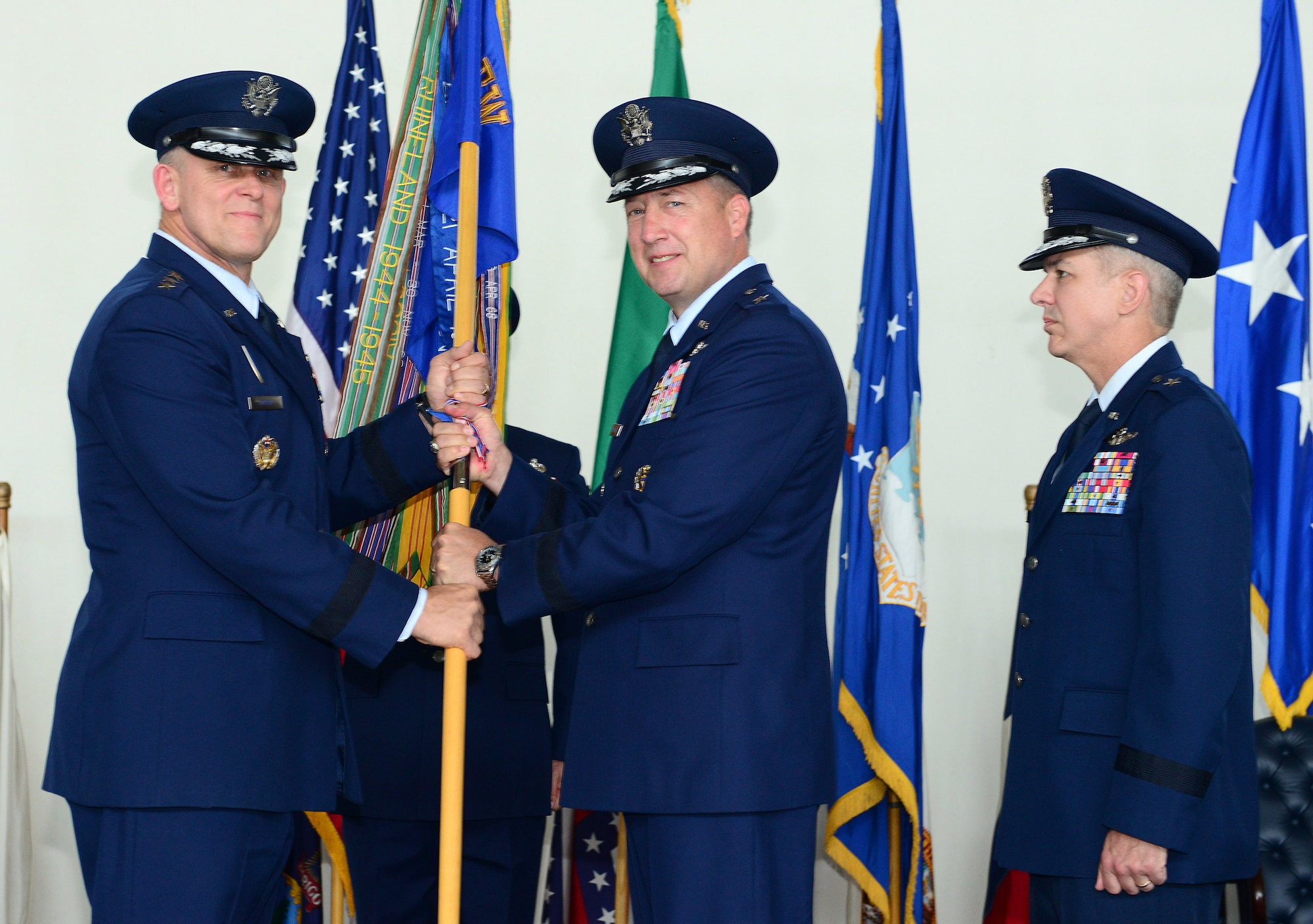 Brig. Gen. Jon A. Norman passes the 31st Fighter Wing guidon to Gen. Frank Gorenc, U.S. Air Forces in Europe, U.S. Air Forces Africa commander, to relinquish command of the 31st FW during the wing change of command ceremony, June 9, 2014, at Aviano Air Base, Italy. Norman will serve as the chief of staff for the Pacific Air Forces at Joint Base Pearl-Harbor Hickam. (U.S. Air Force photo/Senior Airman Matthew Lotz)