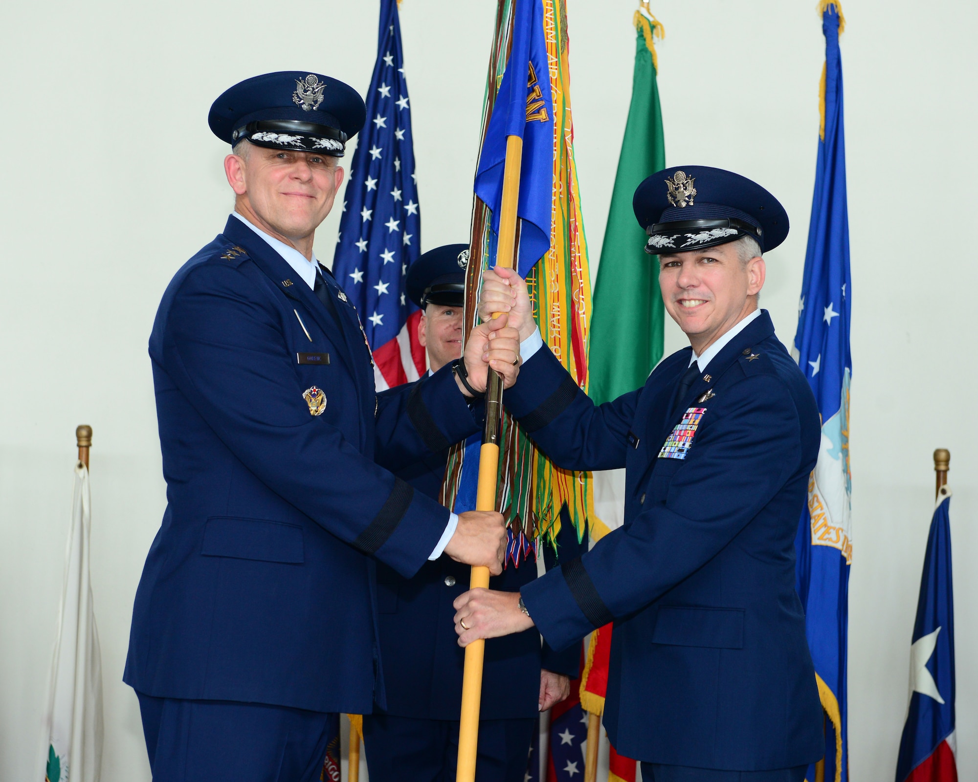 Gen. Frank Gorenc, U.S. Air Forces in Europe, U.S. Air Forces Africa commander, passes the 31st Fighter Wing guidon to Brig. Gen. Barre R. Seguin during the wing change of command ceremony, June 9, 2014, at Aviano Air Base, Italy. Hundreds of Team Aviano members attended the ceremony and watched Seguin become the 13th commander to take the reins of the 31st FW since it relocated to Aviano, Italy from Homestead, Fla. (U.S. Air Force photo/Senior Airman Matthew Lotz)
