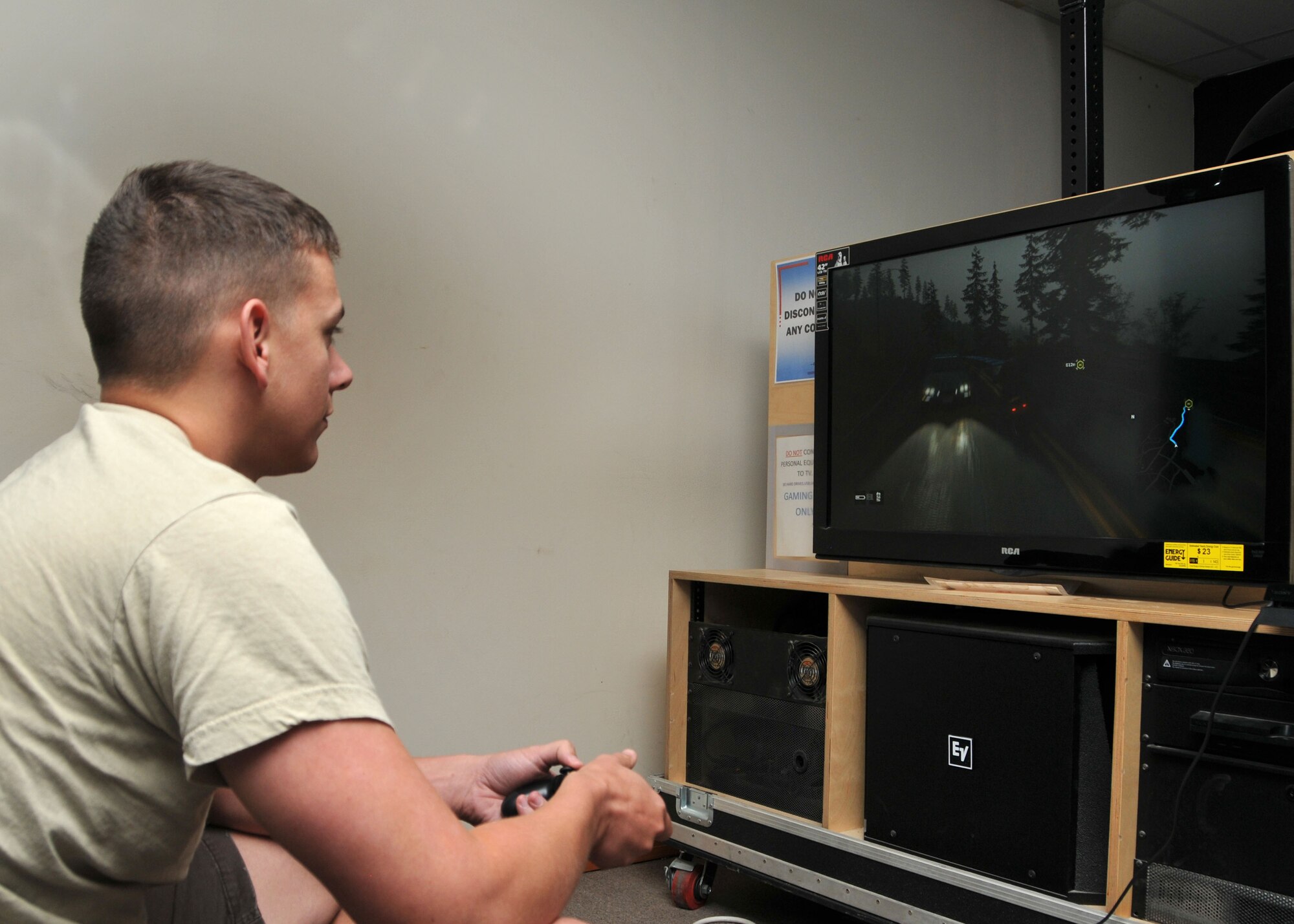 Air Force Senior Airman Zachary Osius plays a game in the video room of the 380th Air Expeditionary Wing’s community activities center at an undisclosed location of Southwest Asia, June 4, 2014. (U.S. Air Force photo by Senior Master Sgt. Eric Peterson/Released)
