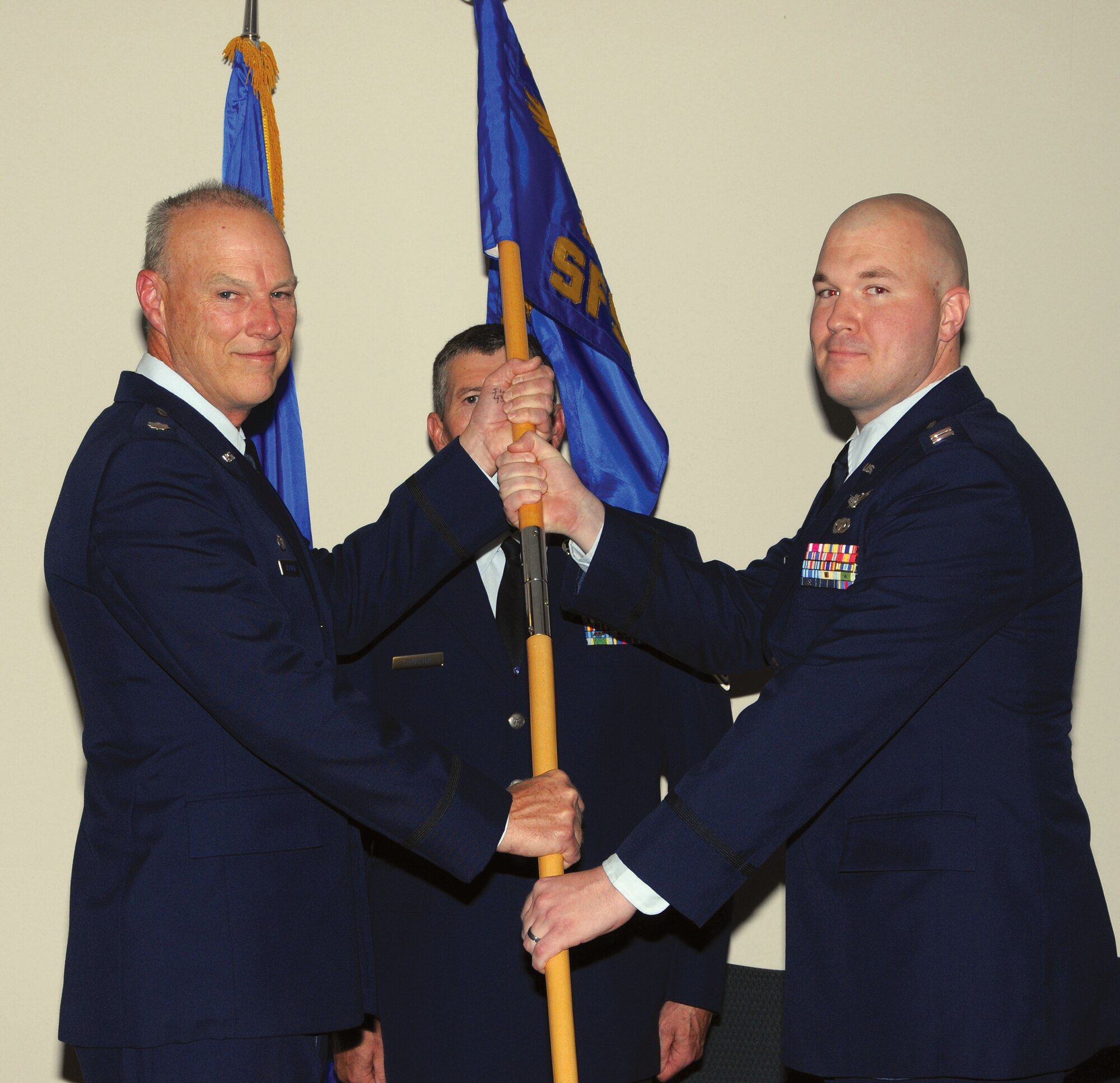 WRIGHT-PATTERSON AIR FORCE BASE, Ohio – Lt. Col. Dale Bateman, 445th Mission Support Group commander, passes the guidon to Capt. Charles Trovarello, incoming 445th Security Forces Squadron commander, during the 445 SFS Change of Command ceremony May 3. (U.S. Air Force photo/Tech. Sgt. Anthony Springer)