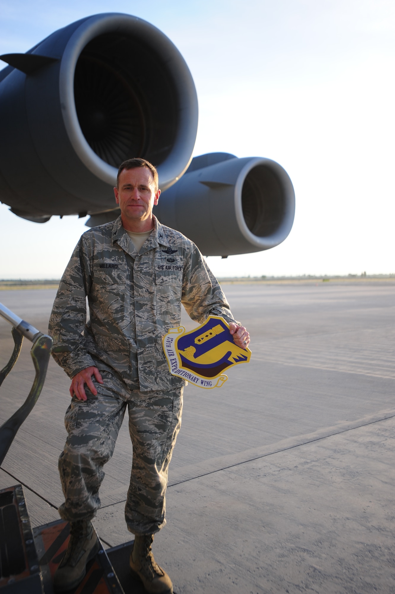 Col. John Millard, 376th Air Expeditionary Wing Commander holds a wing logo before he boards a C-17 Globemaster III and begins making his way home from Kyrgyzstan on June 6, 2014.  The Transit Center at Manas, Kyrgyzstan, flew 33,000 air refueling missions and fueled more than 136,000 coalition aircraft. (U.S. Air Force photo/Lt. Col. Max Despain)