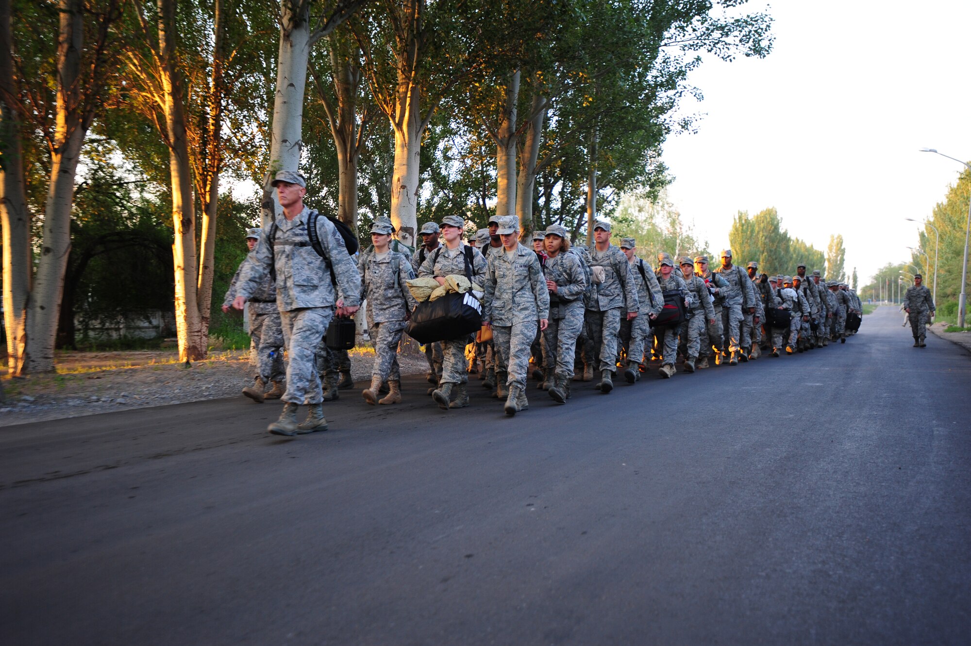 The 376th Air Expeditionary Wing Command Chief, Chief Master Sgt. Gregory Warren, leads the final formation of Liberandos down the street connecting the Transit Center at Manas, Kyrgyzstan with the flight line at Manas International Airport June 6, 2014.  The Transit Center performed four major mission pillars over its 12.5-year tenure:  air refueling, onward movement, air lift and humanitarian assistance. (U.S. Air Force photo/Lt. Col. Max Despain)