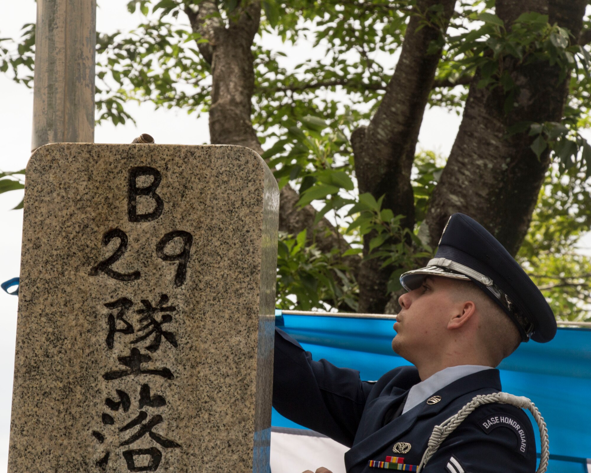 A member of the Yokota Air Base Honor Guard pours bourbon over the B-29 monument during the memorial ceremony in Shizuoka, Japan, June 7, 2014. Every year, U.S. and Japanese service members hike to the Sengen Hill monument in honor of those who lost their lives in the B-29 collision on June 19, 1945. (U.S. Air Force photo by 2nd Lt. Ashley Wright/Released)