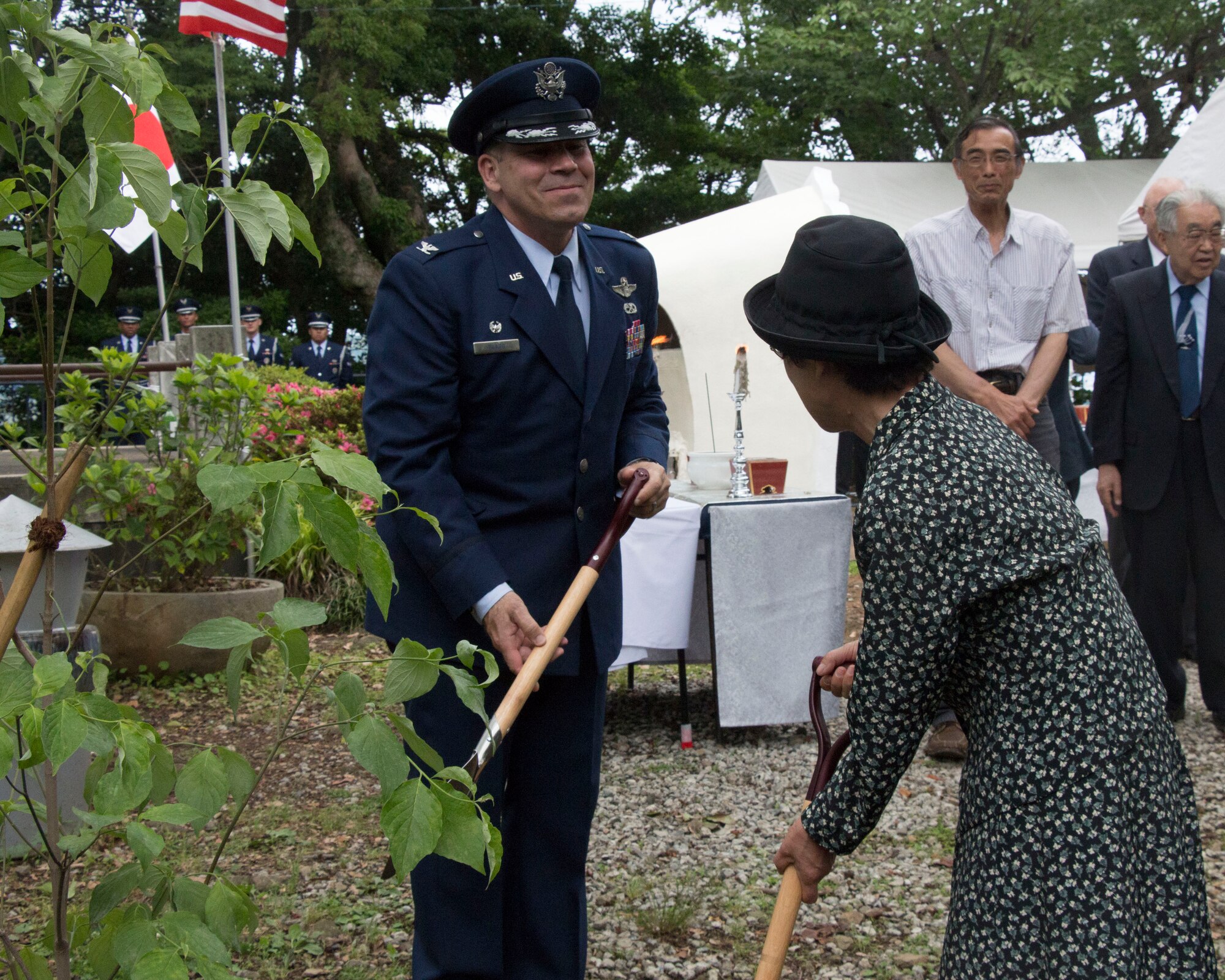 Col. Robert Blagg, Yokota Air Base 374th Operations Group Commander, smiles at a local participant during the traditional Dogwood tree planting ceremony at the B-29 Memorial in Shizuoka, Japan on June 7, 2014. Every year, U.S. and Japanese service members hike to the Sengen Hill monument in honor of those who lost their lives in the B-29 collision on June 19, 1945. (U.S. Air Force photo by 2nd Lt. Ashley Wright/Released)