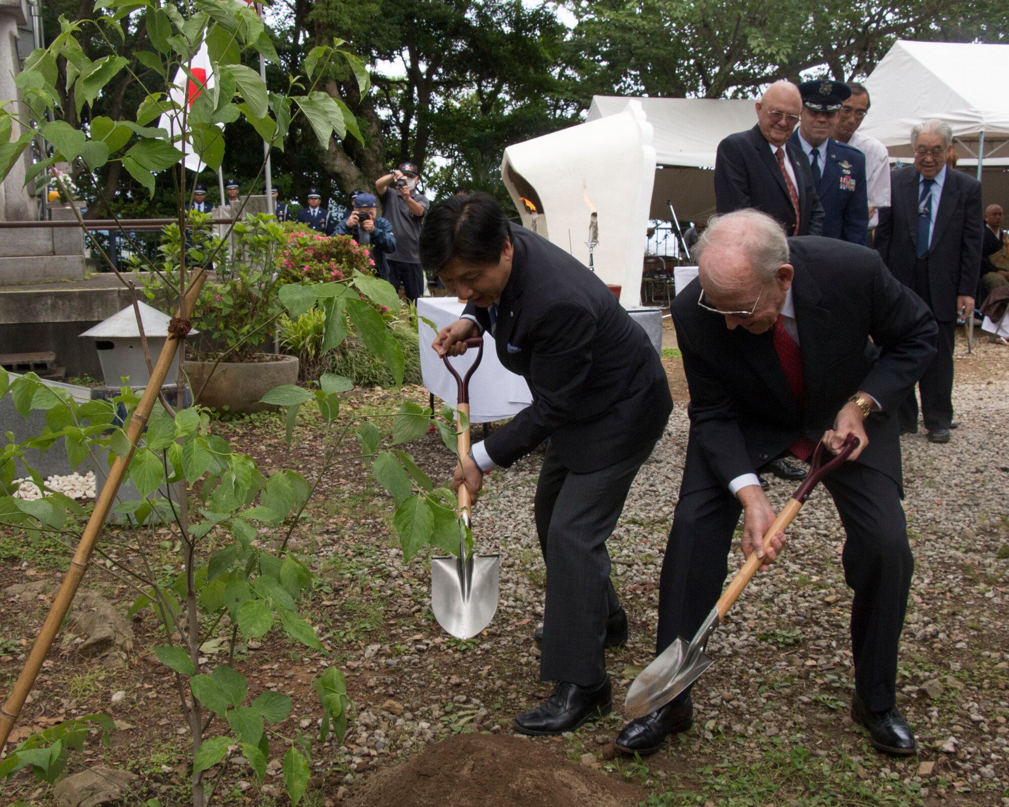Nobuhiro Tanabe, mayor of Shizuoka City, and Retired U.S. Navy Adm. Ronald Hays participate in a traditional Japanese tree-planting ceremony during the B-29 Memorial Ceremony in Shizuoka, Japan, June 7, 2014. Every year, U.S. and Japanese service members hike to the Sengen Hill monument in honor of those who lost their lives in the B-29 collision on June 20, 1945. (U.S. Air Force photo by 2nd Lt. Ashley Wright/Released)