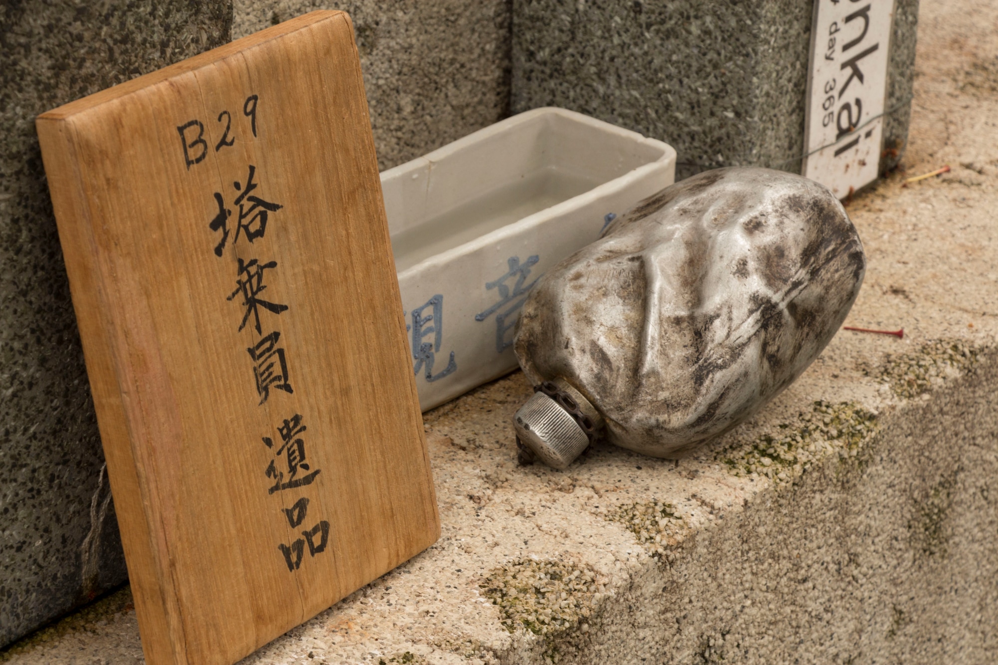 A replica blackened canteen rests on a shrine dedicated to the B-29 collision aircrew victims at the memorial ceremony in Shizuoka, Japan, June 7, 2014. Every year, U.S. and Japanese service members hike to the Sengen Hill monument in honor of those who lost their lives on June 19, 1945. (U.S. Air Force photo by 2nd Lt. Ashley Wright/Released)