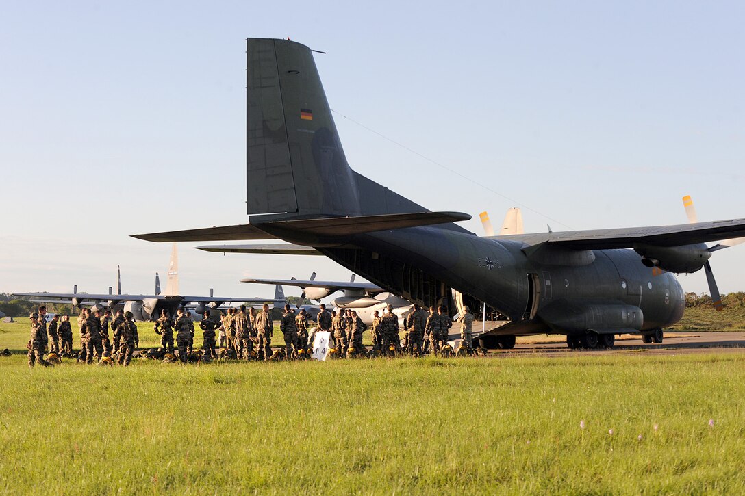 International paratroopers prepare to board a German C-160 aircraft in ...