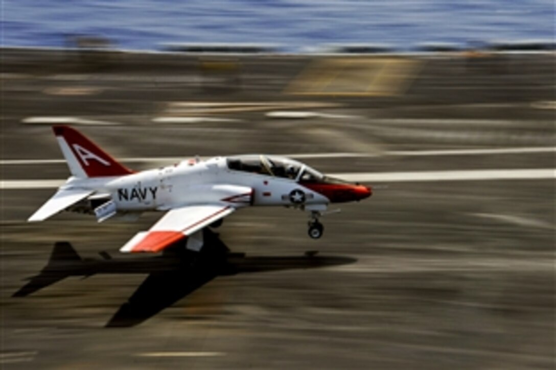 A T-45 Goshawk performs a touch and go on the flight deck of the aircraft carrier USS Theodore Roosevelt in the Atlantic Ocean, June 7, 2014. The Roosevelt is preparing for future deployments.