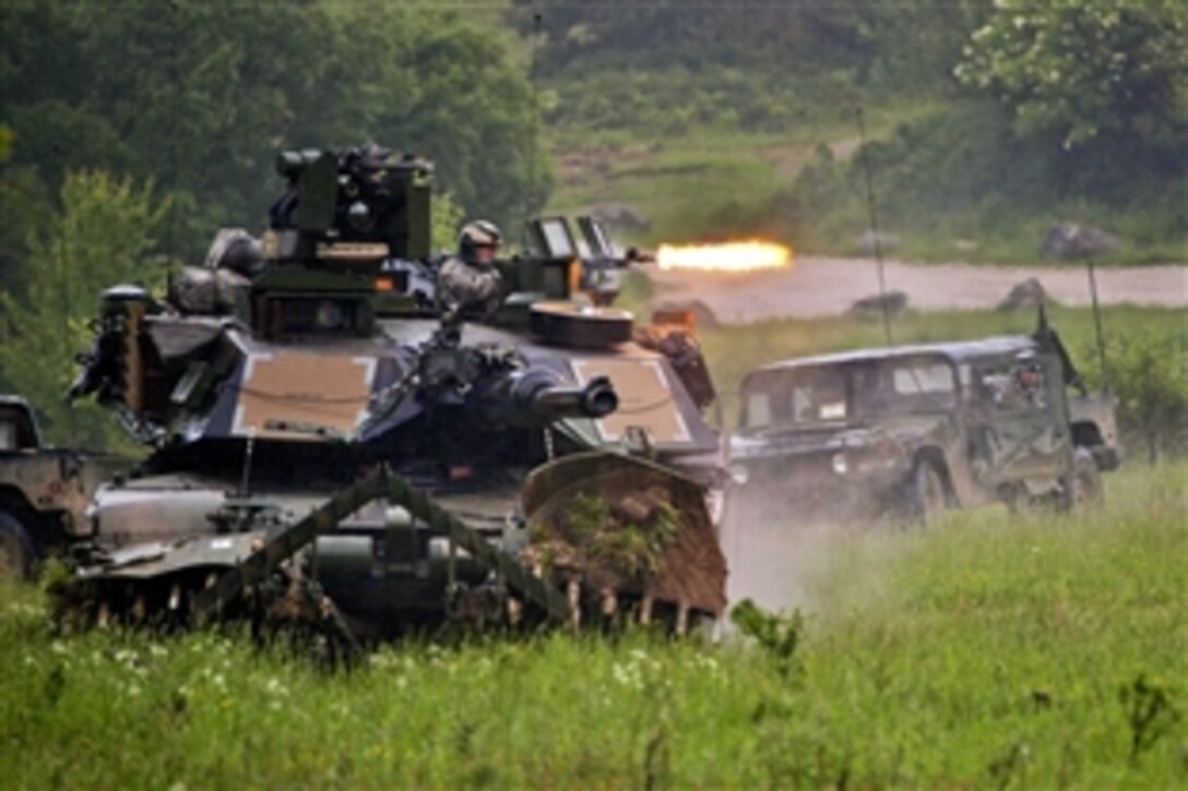 U.S. soldiers in an M1A2 Abrams tank hunt for the enemy during Combined Resolve II at the Joint Multinational Readiness Center in Hohenfels, Germany, May 29, 2014. The soldiers are assigned to the 1st Cavalry Division's 2nd Battalion, 5th Cavalry Regiment, 1st Brigade Combat Team. 