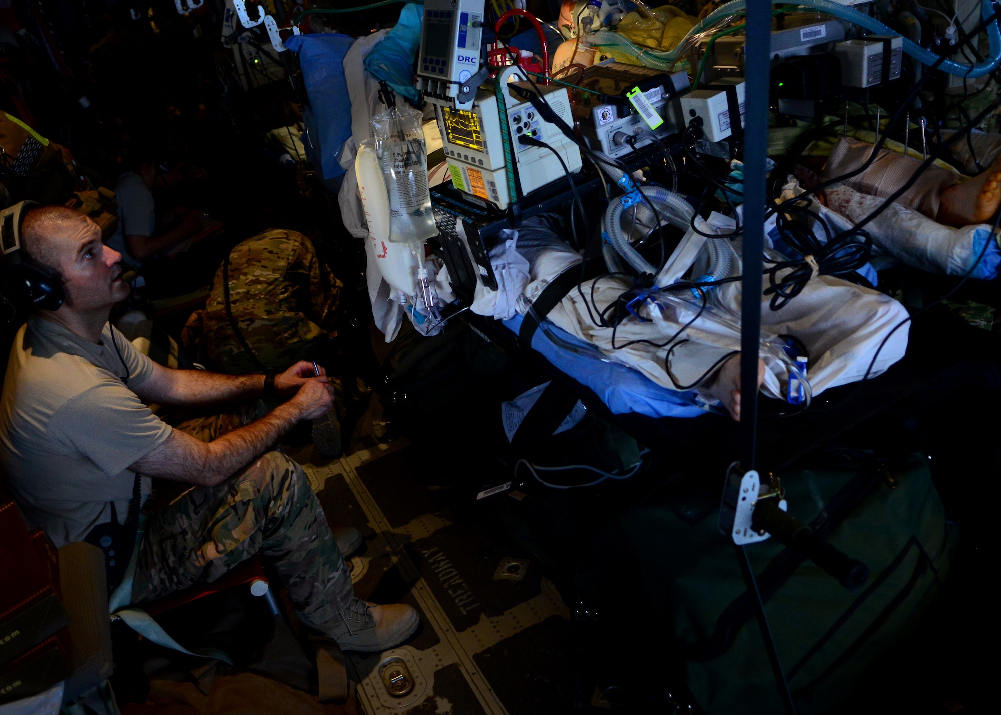 U.S. Air Force Capt. Nathan Buck, 455th Expeditionary Aeromedical Evacuation Squadron Critical Care Air Transport Team medical provider, watches a patient during a flight to Bagram Airfield, Afghanistan, May 29, 2014. (U.S. Air Force photo by Staff Sgt. Evelyn Chavez)