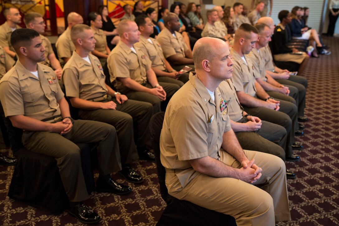Graduates of the College of Distance Education and Training Command and Staff, Expeditionary Warfare School and U.S. Naval War College enjoy the graduation ceremony in Talbot’s Dining Room aboard Marine Corps Air Station Iwakuni, Japan, June 4, 2014. Service members with the CDET attended a course that lasted two years aboard station instead of going to the yearlong residential school in the U.S.
