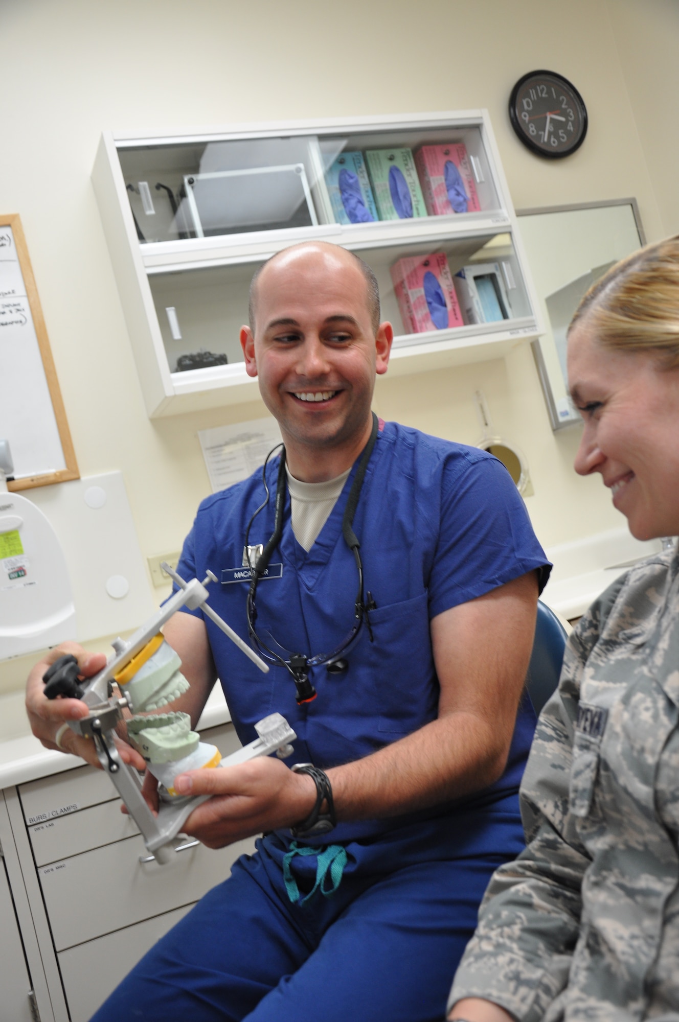 Capt. Robert MacArthur talks with an Airman June 5, 2014, at the 60th Dental Squadron clinic at Travis Air Force Base, Calif. A gay man, MacArthur stayed in the closet during the armed forces' 17-year observance of "Don't Ask, Don't Tell." MacArthur is a 60th Dental Squadron dentist and the president of the Travis AFB Lesbian, Gay, Bisexual and Transgender Alliance. (U.S. Air Force photo/Staff Sgt. Christopher Carranza)